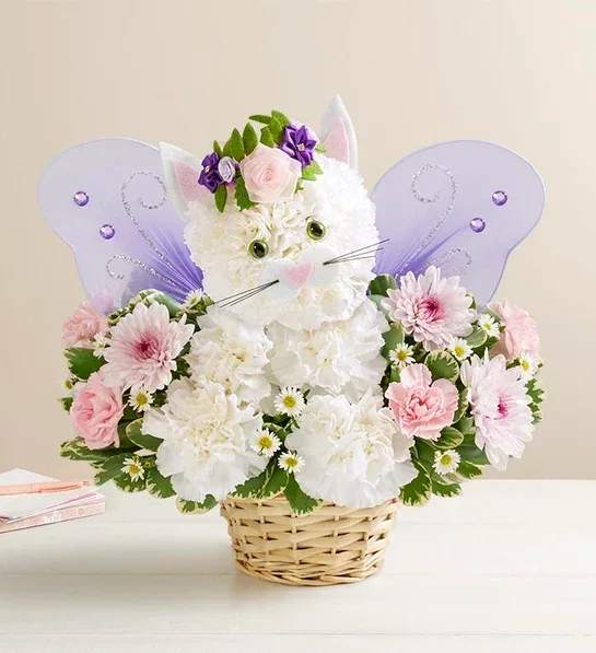 Flower basket arranged as a white cat with purple butterfly wings