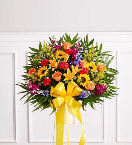 Heartfelt Sympathies color's Standing Basket - Pet Friendly? No - This arrangement contains Asiatic Lilies, which are highly toxic to cats and can cause kidney failure even in small amounts.  It is best to keep this away from homes with curious cats or household pets.   Human Allergy Note : Pollen-heavy flowers present. Both Sunflowers and Asiatic Lilies produce significant pollen. We recommend gently snipping the orange anthers from the center of the lilies as they open to reduce sneeze triggers and prevent fabric staining.   Care &amp; Longevity : Since this arrangement is designed in floral foam within a basket, it requires consistent hydration. Gently pour a small amount of fresh water into the center of the basket daily to keep the foam saturated. Keep the display in a cool area away from direct sunlight, heating vents, or harsh drafts.  Best Occasions &amp; Situations : - Funeral service or memorial - Church altar display - Celebration of life ceremony - Large-scale home tribute - Expressing deep sympathy - Honoring a vibrant personality - Graveside service  Why Customers Love It : - Vibrant color balance that celebrates a life with joy rather than just sadness. - Impressive height and scale, making it easily visible from the back of a chapel. - Gift-ready presentation on a professional wire easel for easy setup. - Classic floral variety that appeals to traditional and modern tastes alike. - Fresh, local feel that stands out among standard funeral arrangements.