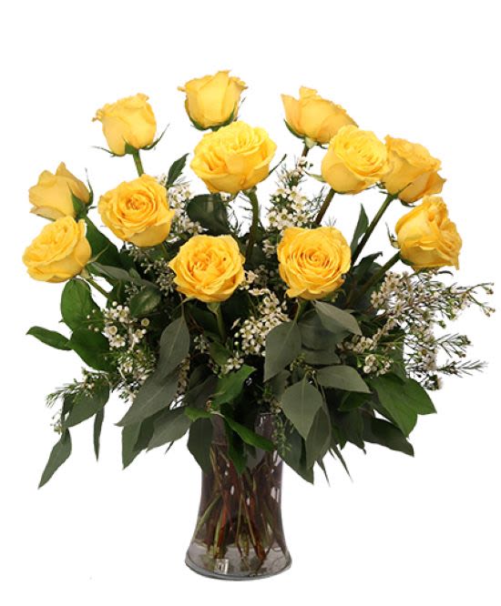 Yellow roses arranged in a clear glass vase