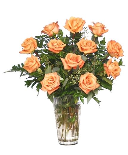 Orange roses arranged in a clear glass vase