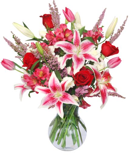 Bouquet of pink lilies and red roses in a glass vase