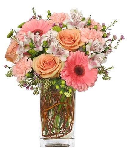 Pink and peach mixed bouquet in a clear rectangular vase