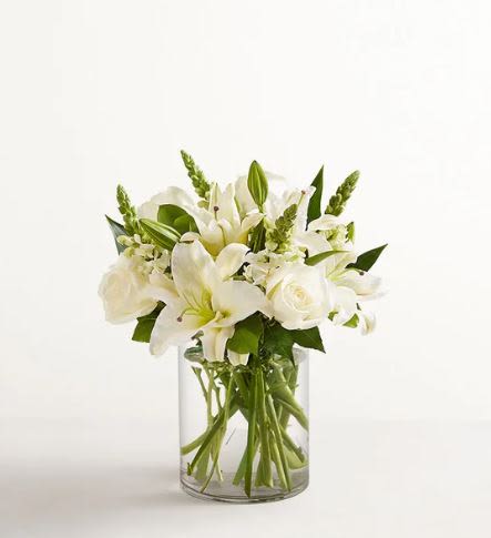 Classic All White Flower  - Pet Friendly? No - This arrangement contains Oriental Lilies, which are highly toxic to cats; even small amounts of pollen or vase water can cause kidney failure. Use Caution around dogs as well.  Keep out of reach and avoid homes with curious cats.   Human Allergy Note : This arrangement contains pollen-heavy Oriental Lilies. If you are sensitive to strong floral scents or pollen, consider removing the orange anthers from the center of the lilies as they open. Keep the arrangement in a well-ventilated area and away from bedside tables.  Care &amp; Longevity : To keep these white blooms pristine, trim the stems at a 45-degree angle every two days and place them in a clean vase with fresh, room-temperature water. Remove any leaves that fall below the waterline to prevent bacteria growth.   Best Occasions &amp; Situations : - Elegant anniversary surprise - Get well soon / Comfort - Sophisticated housewarming gift - Formal corporate event or gala - Classic “just because” gesture - Milestone birthday celebration  Why Customers Love It : - Timeless Aesthetic: The all-white palette fits perfectly with any home decor style. - Impressive Height: The tall snapdragons and lilies create a grand focal point for entryways or tables. - Fragrant Experience: The lilies fill the entire home with a fresh, natural perfume. - Versatile Gifting: It is a high-trust choice for both celebratory and somber occasions.