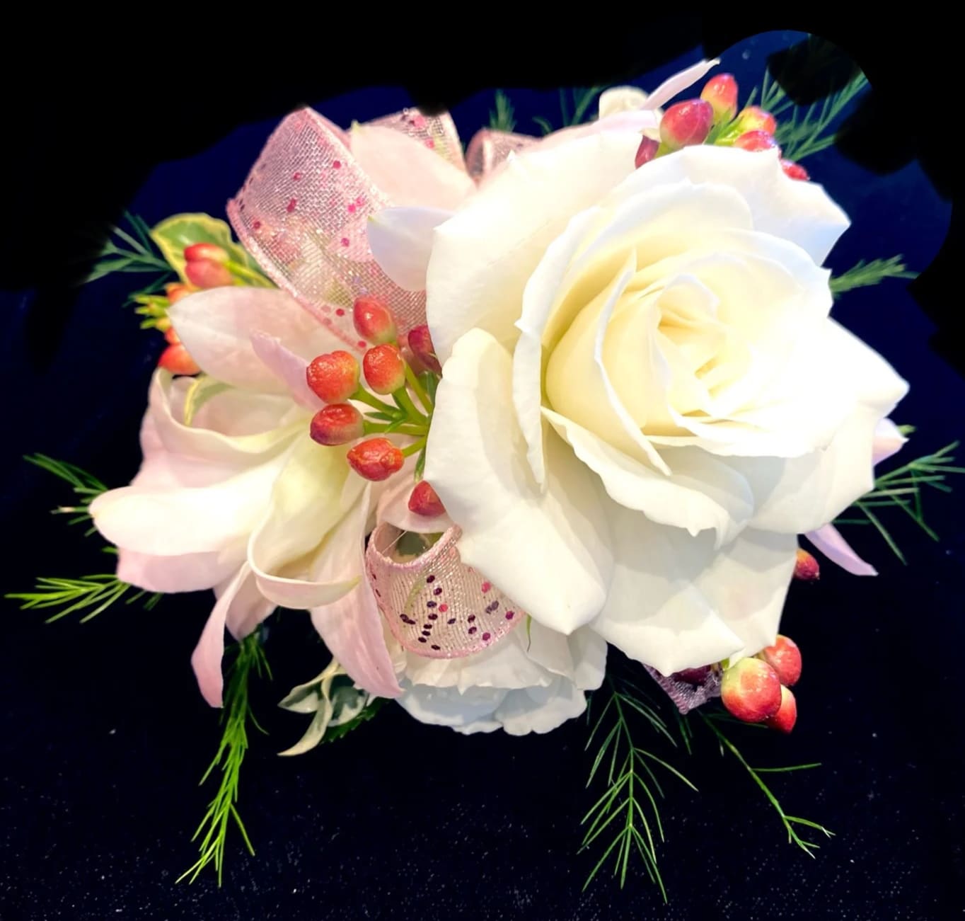 Classic  White and Pink Wrist Corsage - A classic; white spray roses with pink accents and sheer pink gliitter ribbon.   PLEASE CALL THE SHOP AT (617)244-4422 FOR ALL CORSAGE OR BOUTONNIERE ORDERS. THANK YOU.