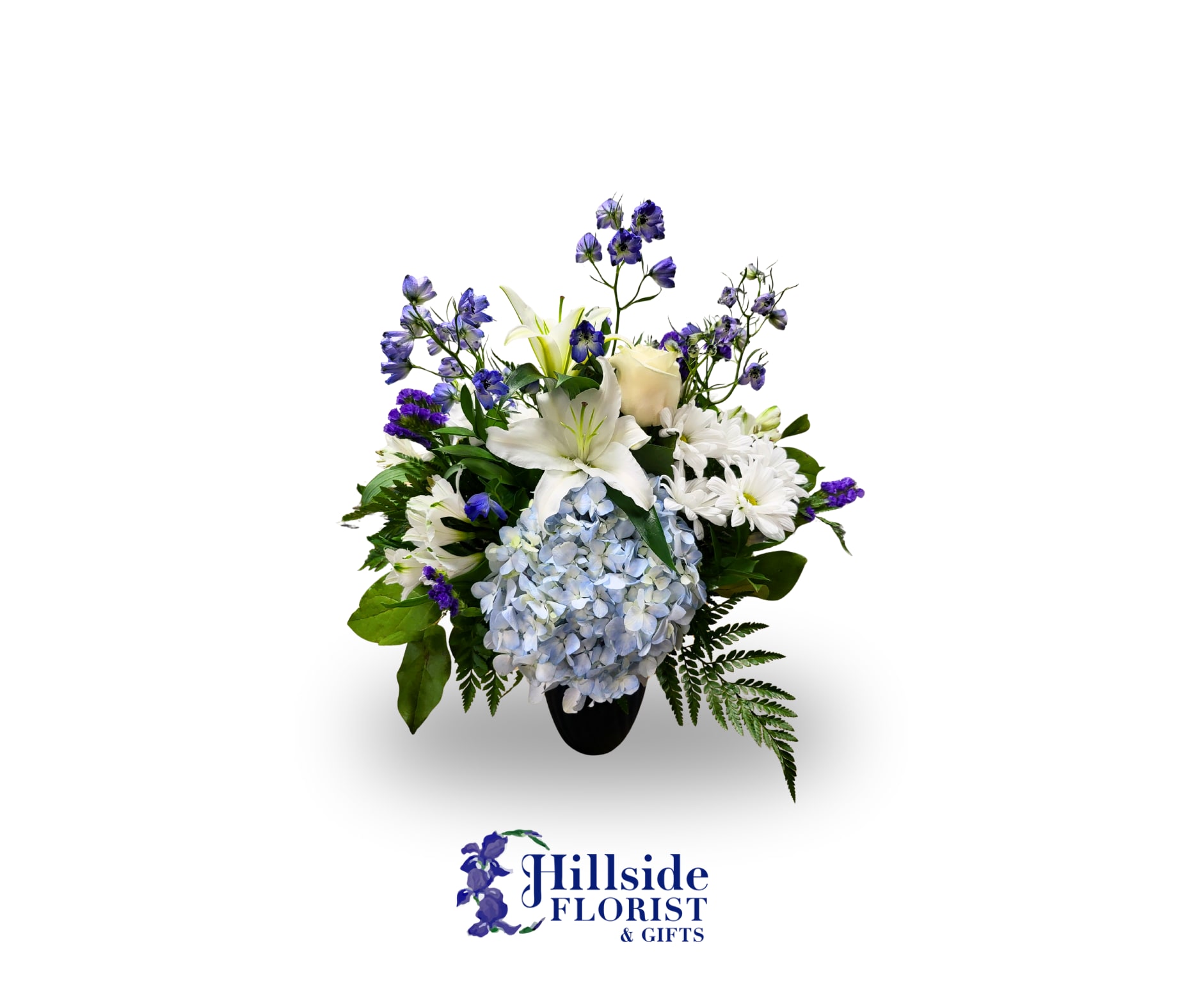White lilies, blue hydrangea, and purple flowers in a black vase