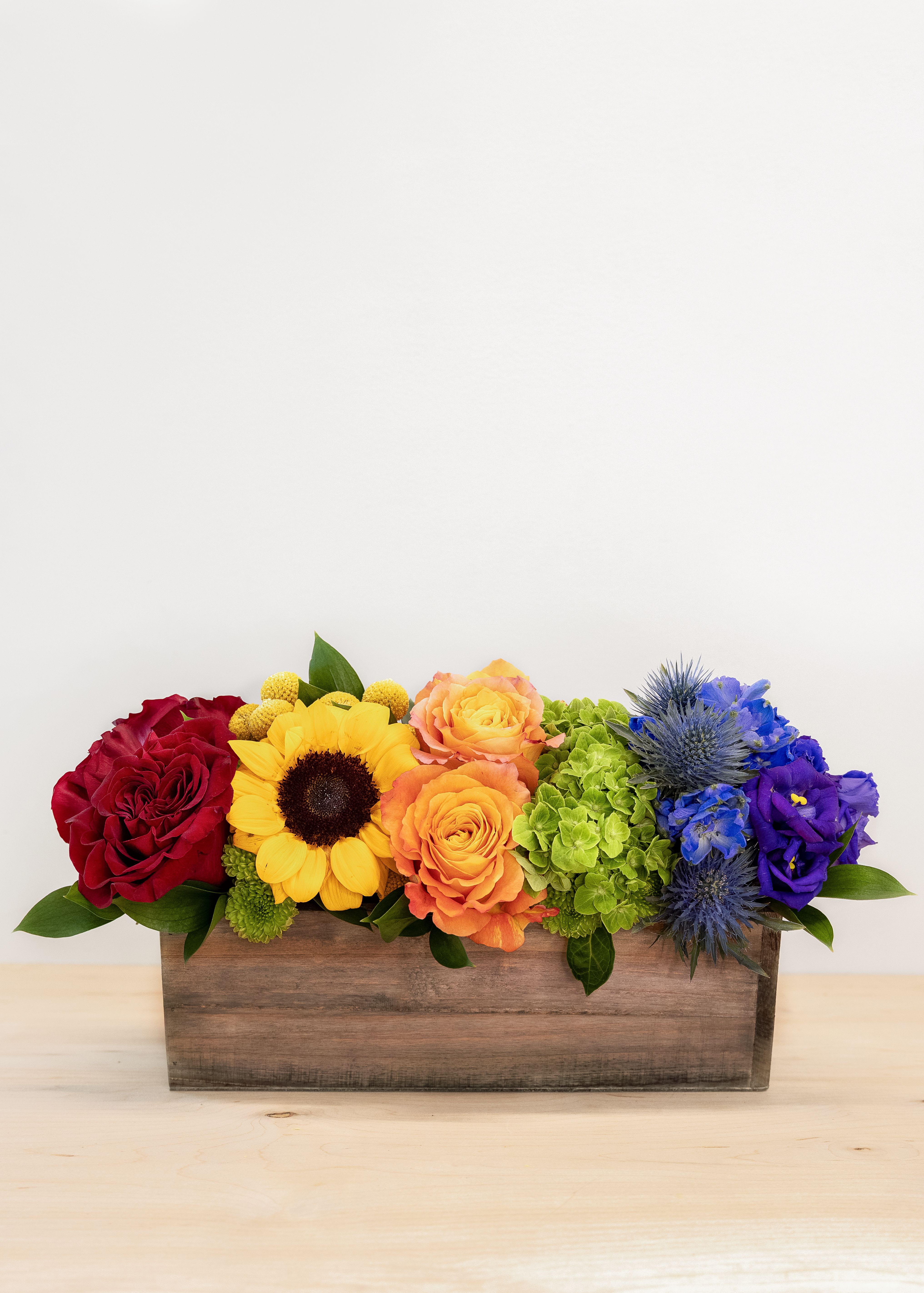 Ravishing Rainbow - A boxed mix of beautiful rainbow stems.  Celebrate PRIDE, Celebrate LOVE, and Celebrate a world filled with all the colors of a Ravishing Rainbow.  In the month of JUNE, 20% of Profits from the Ravishing Rainbow are donated to local LGBTQ+ organizations.  Standard is 14" long by 7" tall.