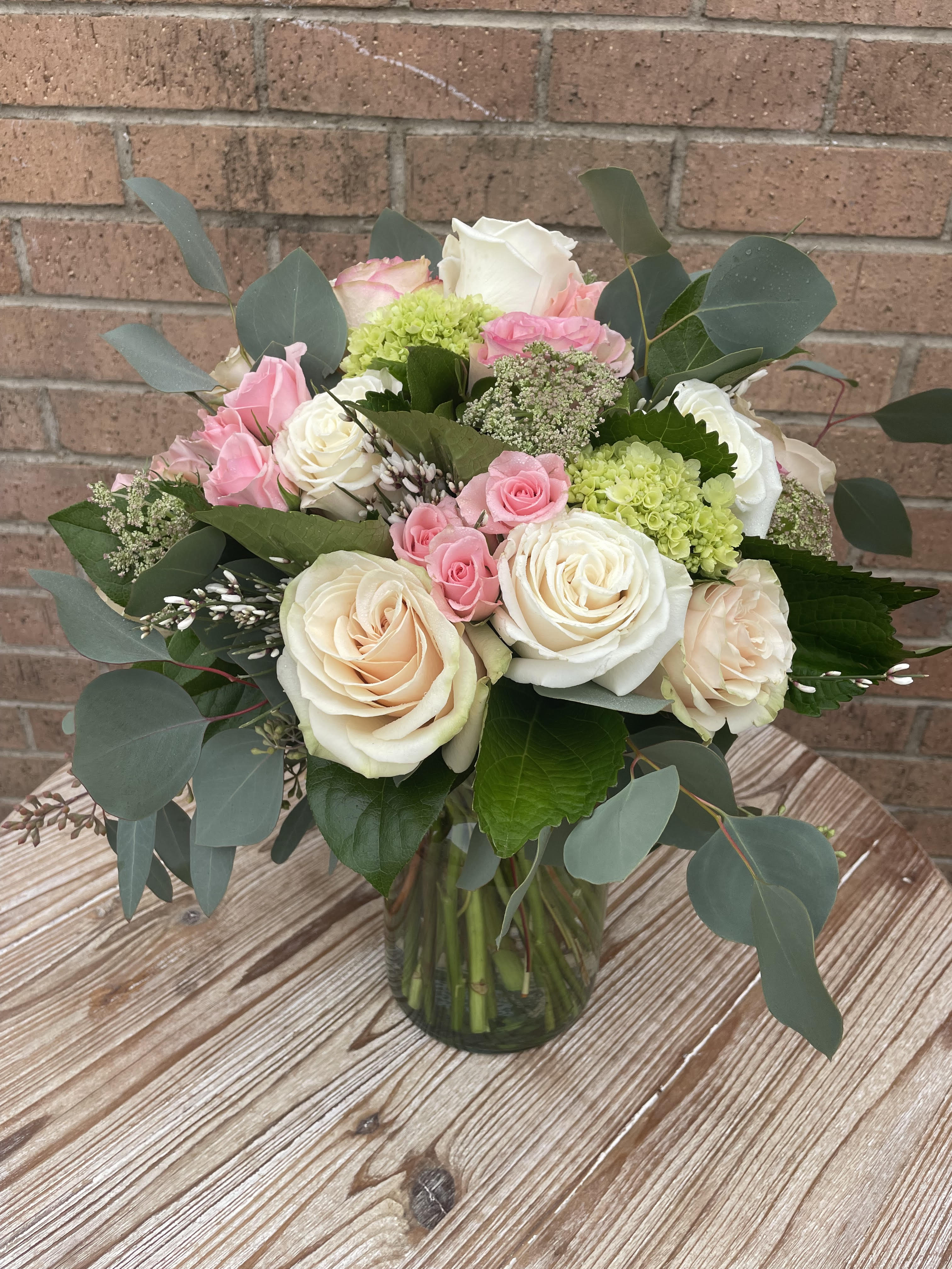 Bouquet of pink and white roses in a glass vase