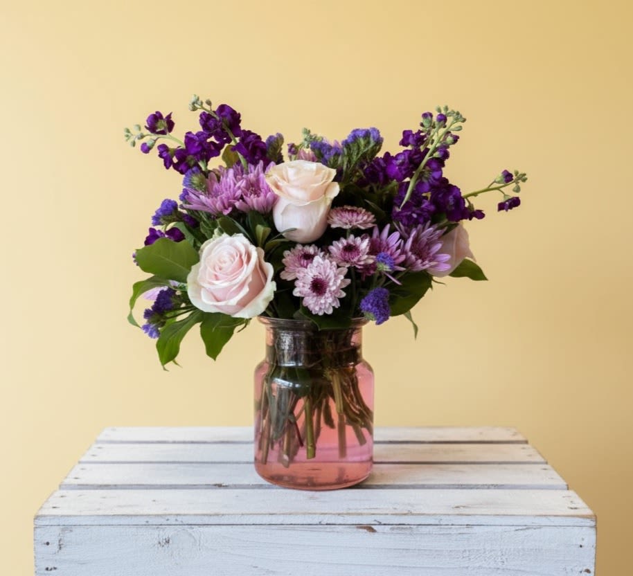 Coming Home - A selection of pink and purple flowers come together in an eye-pleasing arrangement. This arrangement makes a great gift for Mother's Day, Women's Day, or as a thinking of you present.  Approximate Dimensions: 16''D x 10''H