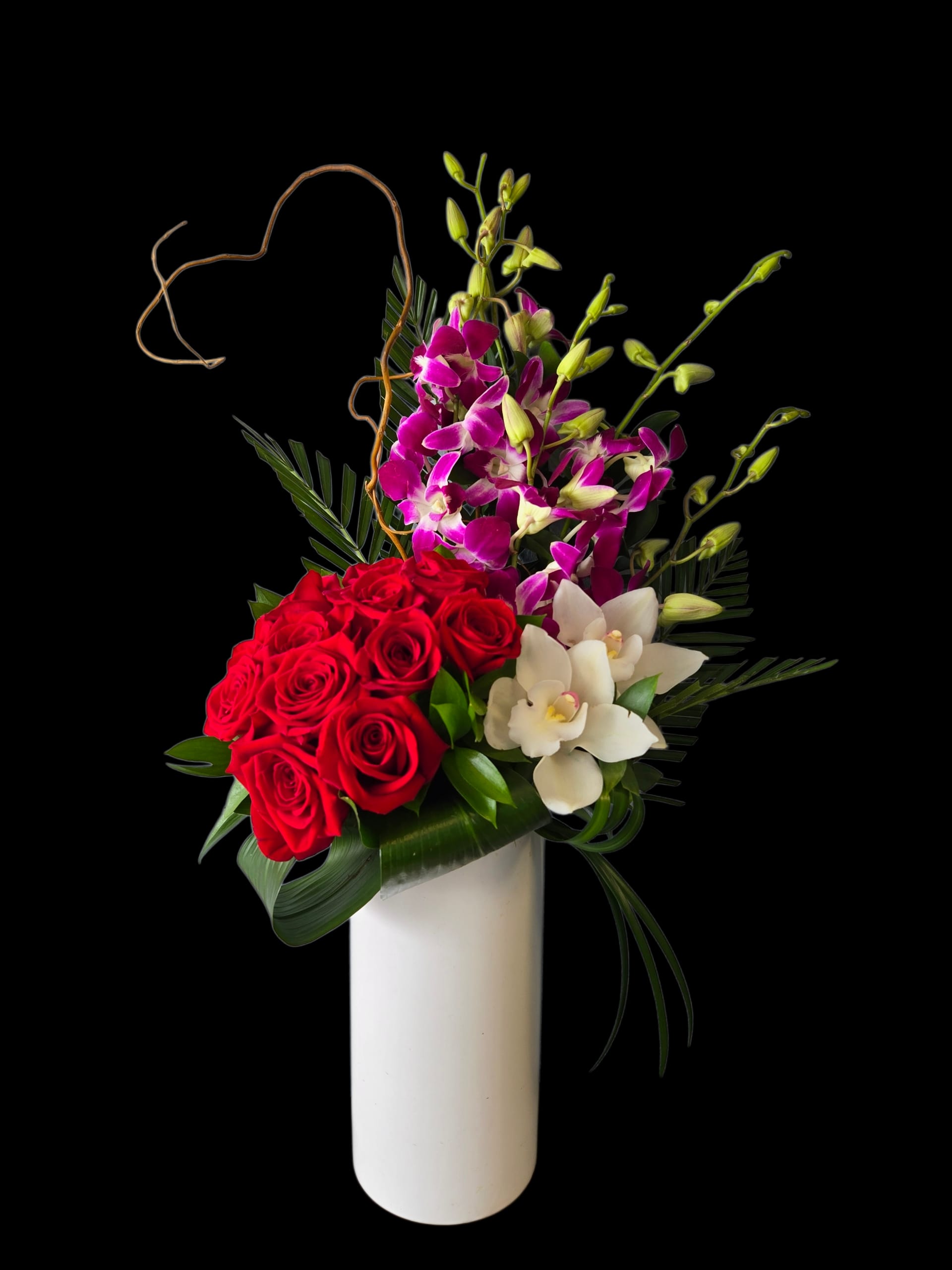 Red roses and purple orchids in a white vase