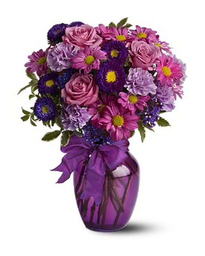 Purple and pink mixed bouquet in a purple vase with a ribbon