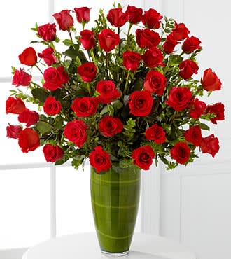 Fascinating Luxury Rose Bouquet - 36 Premium Long-Stemmed Roses - Fascinate and captivate your love. Nothing speaks from the heart more than our 24-inch premium long-stemmed rich red roses, situated in a superior 14-inch clear glass tapered bullet vase to create a classic display with a romantically sophisticated twist. A symbol of pure love and affection throughout the ages, this bouquet of our finest red roses will capture their heart. Includes: 40 stems of 24-inch premium long-stemmed red roses, assorted greens, exotic foliage and a superior 14-inch clear glass tapered bullet vase. Approx. 34H x 28W