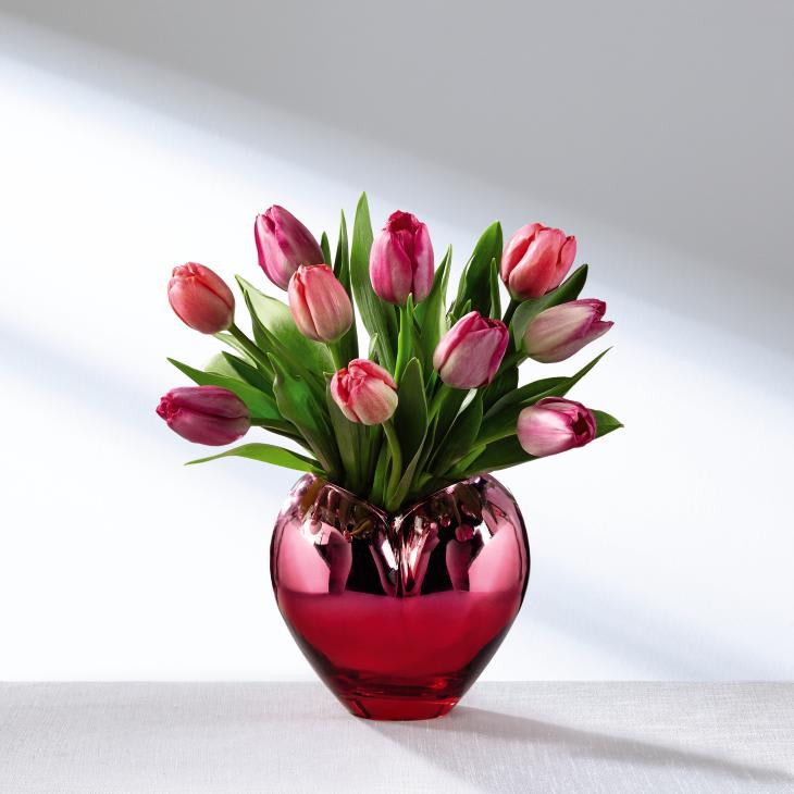 The FTD Season of Love Bouquet - Valentine's Day is just around the corner and this stunning bouquet is ready to celebrate. Blushing assorted pink tulips are blossoming with a sweet sophistication presented in a shining heart-shaped ceramic vase with a reflective metallic finish that catches the light from every direction. A wonderful way to share in the love this February 14th with a favorite friend, a family member, or your special sweetheart in honor of this fun and romantic holiday! GOOD bouquet includes 10 stems. Approx. 12"H x 11"W. BETTER bouquet includes 15 stems. Approx. 13"H x 12"W. BEST bouquet includes 20 stems. Approx. 14"H x 13"W. EXQUISITE bouquet includes 25 stems. Approx. 15"H x 13"W.