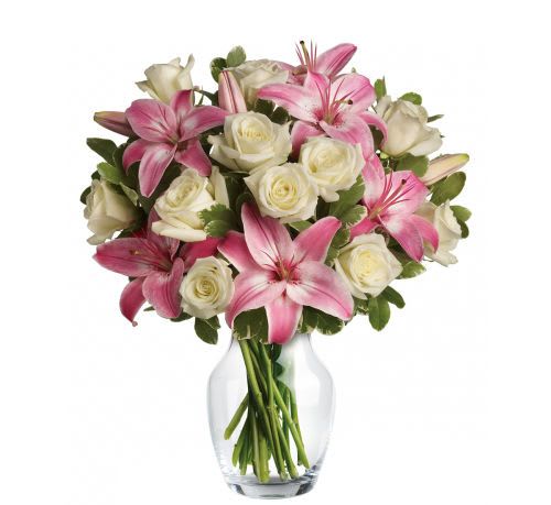 Always a Lady Bouquet - A stunning gift like this one is always appreciated. An eye-catching display of roses and lilies is perfectly arranged in a feminine vase which makes a beautiful and lasting impression. Elegant white roses and sweet pink asiatic lilies are hand-arranged with greens. It's the perfect way to show you love her always and forever.