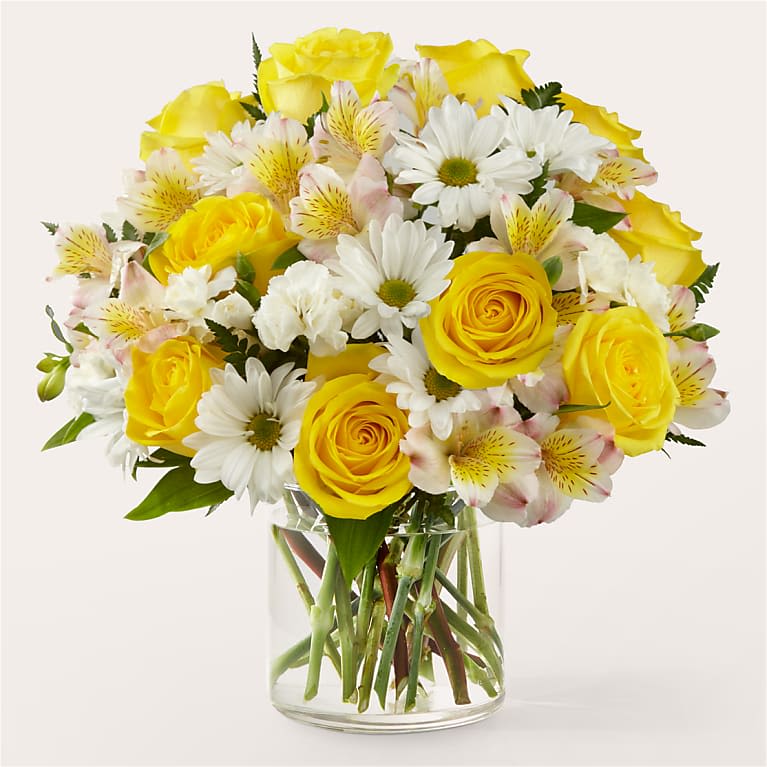 ️ "Golden  Bouquet" - A Fresh Burst of Sunshine and Smiles!  The Golden  Bouquet radiates warmth and happiness with a lively mix of bright yellow roses, white daisies, soft pink alstroemeria, and delicate white carnations — all beautifully arranged in a clear glass vase. It's a fresh and uplifting way to celebrate any special moment!   Fresh, hand-selected seasonal blooms  Perfect for birthdays, thank-yous, or “just because” gifts  Ready-to-display — vase included   Light up someone’s day with golden blooms and heartfelt joy!  