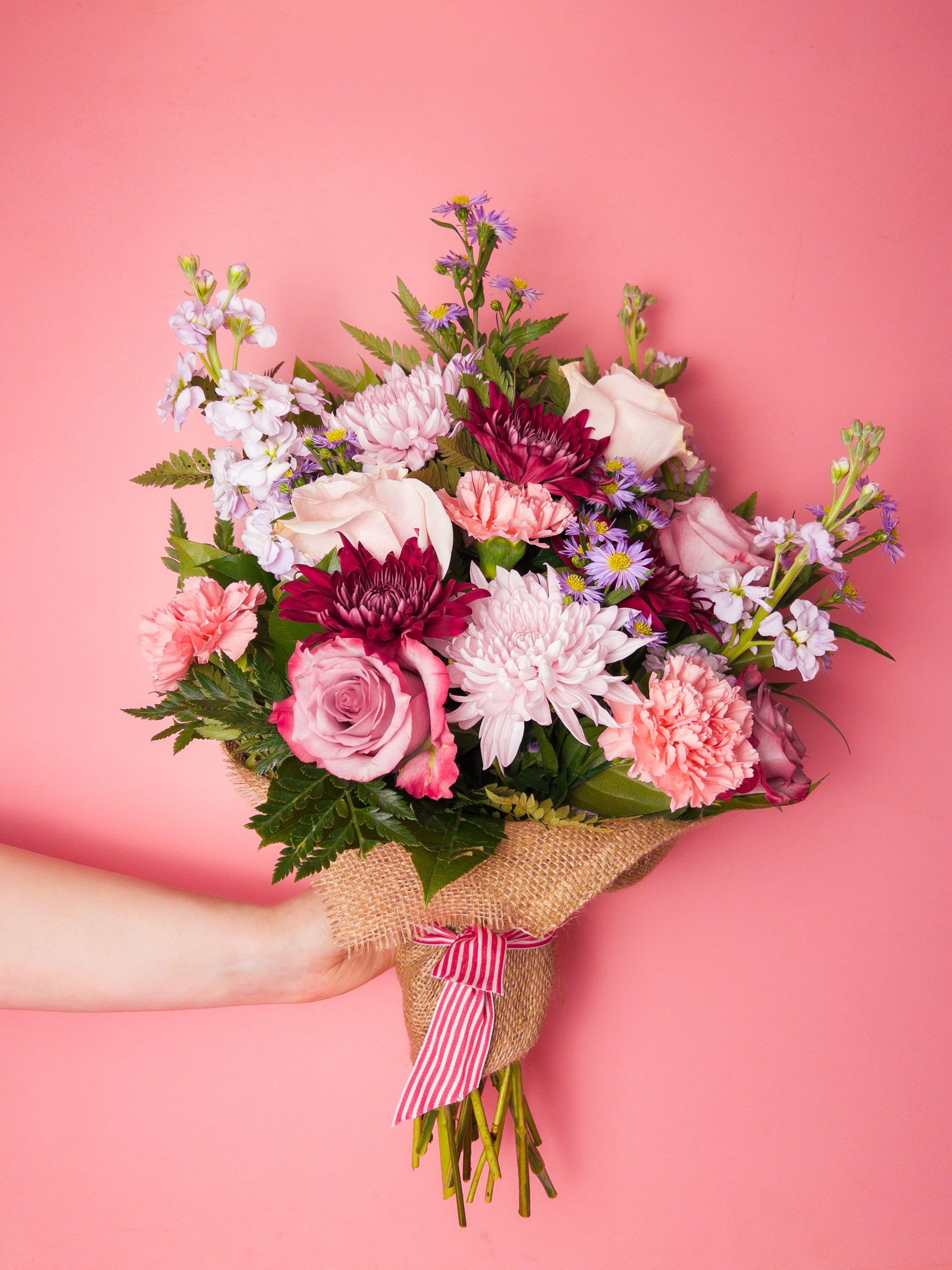 Hugs of Hues Bouquet - Celebrate Mother’s Day with the Hugs of Hues Bouquet, featuring a lively mix of purple and pink flowers hand-tied into a stunning spring bouquet. This colorful design feels joyful and energetic, making it a perfect gift to brighten Mom’s day. Its balanced color palette makes it ideal for display in any vase at home or work. Your local Baltimore Florist is dedicated to creating bouquets that bring happiness and beauty to every occasion. With reliable Flower Delivery in Baltimore, sending a thoughtful Mother’s Day bouquet has never been easier.