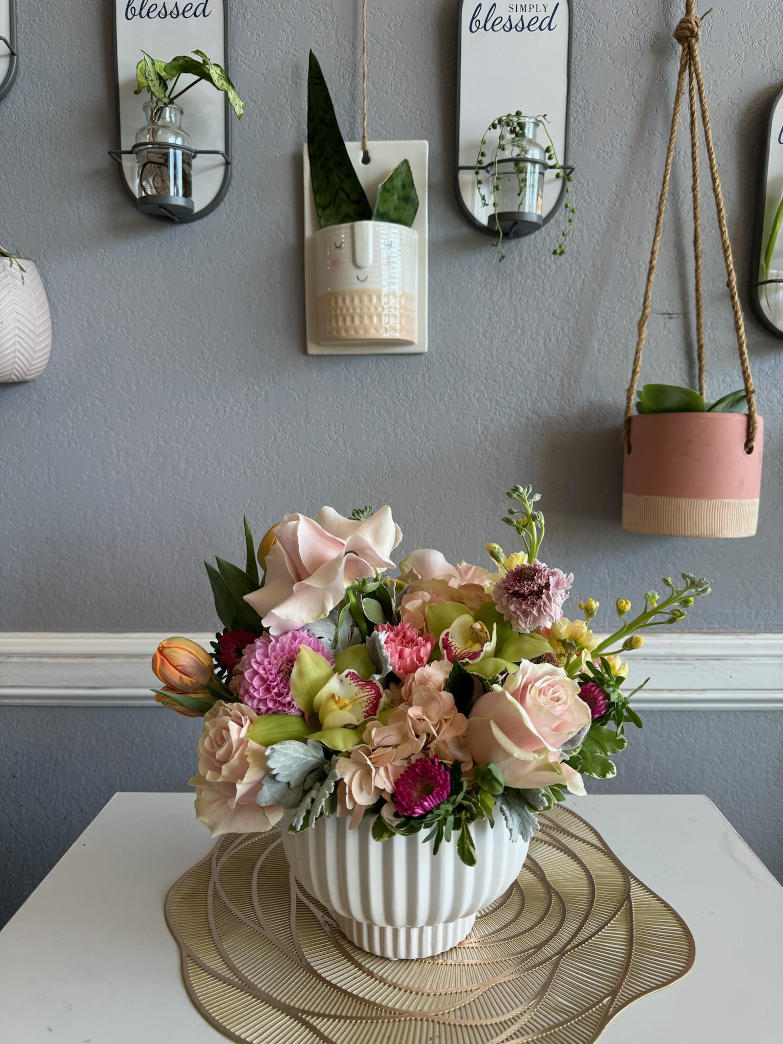 Mixed pastel flower arrangement in a white ribbed vase