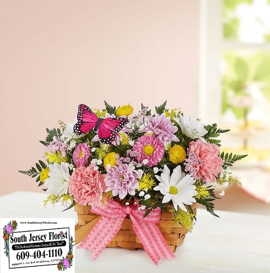 Blossoming Blooms Basket - Our charming basket of blooms is an easy, go-to gift for any occasion. This sweet arrangement features a pastel floral mix inside a handled basket. Complete with a pink ribbon and playful butterfly accent, it’s designed to delight the people you love.  All-around arrangement with pink Matsumoto asters, carnationsm,m, yellow button poms and white daisy poms; accented with baby’s breath, assorted greenery and butterfly pick (color and style may vary) Artistically designed in a handled basket with bow and liner; measures 7"H Large arrangement measures approximately 13"H x 14"W Medium arrangement measures approximately 12.5"H x 13.5"W Small arrangement measures approximately 12"H x 13"W Our florists select the freshest flowers available, so colors, varieties and container may vary due to local availability