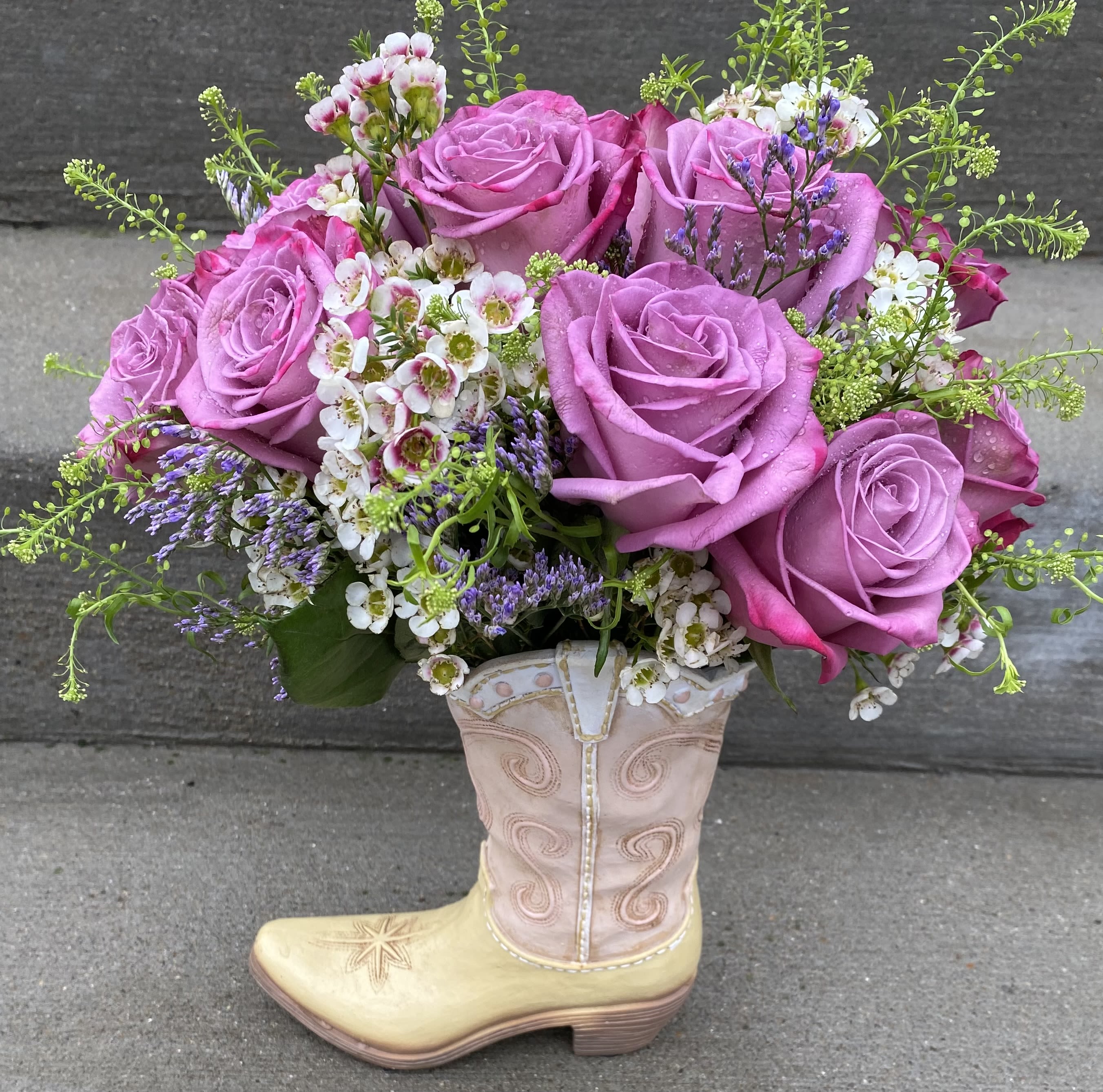 Pink rose bouquet arranged in a decorative cowboy boot