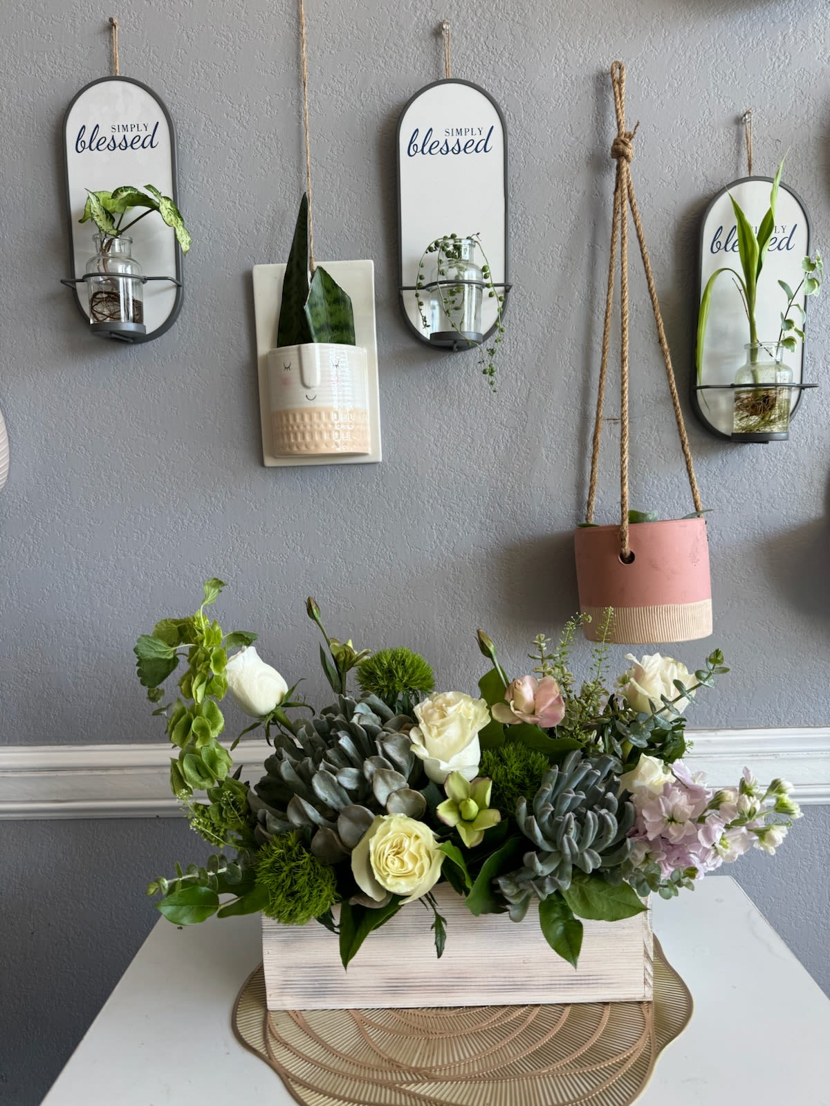 Succulent and rose arrangement in a white wooden box