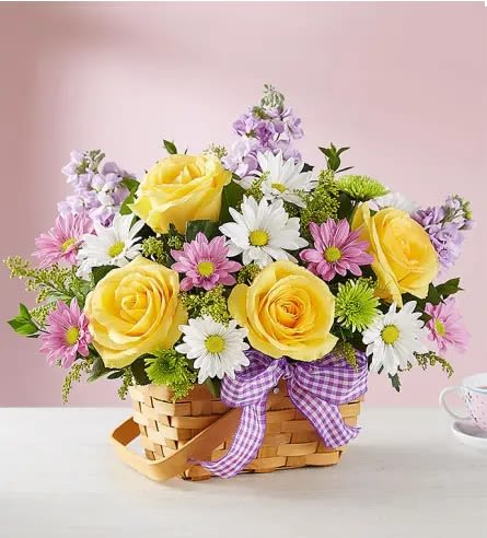 Basket of yellow roses and daisies with a purple ribbon
