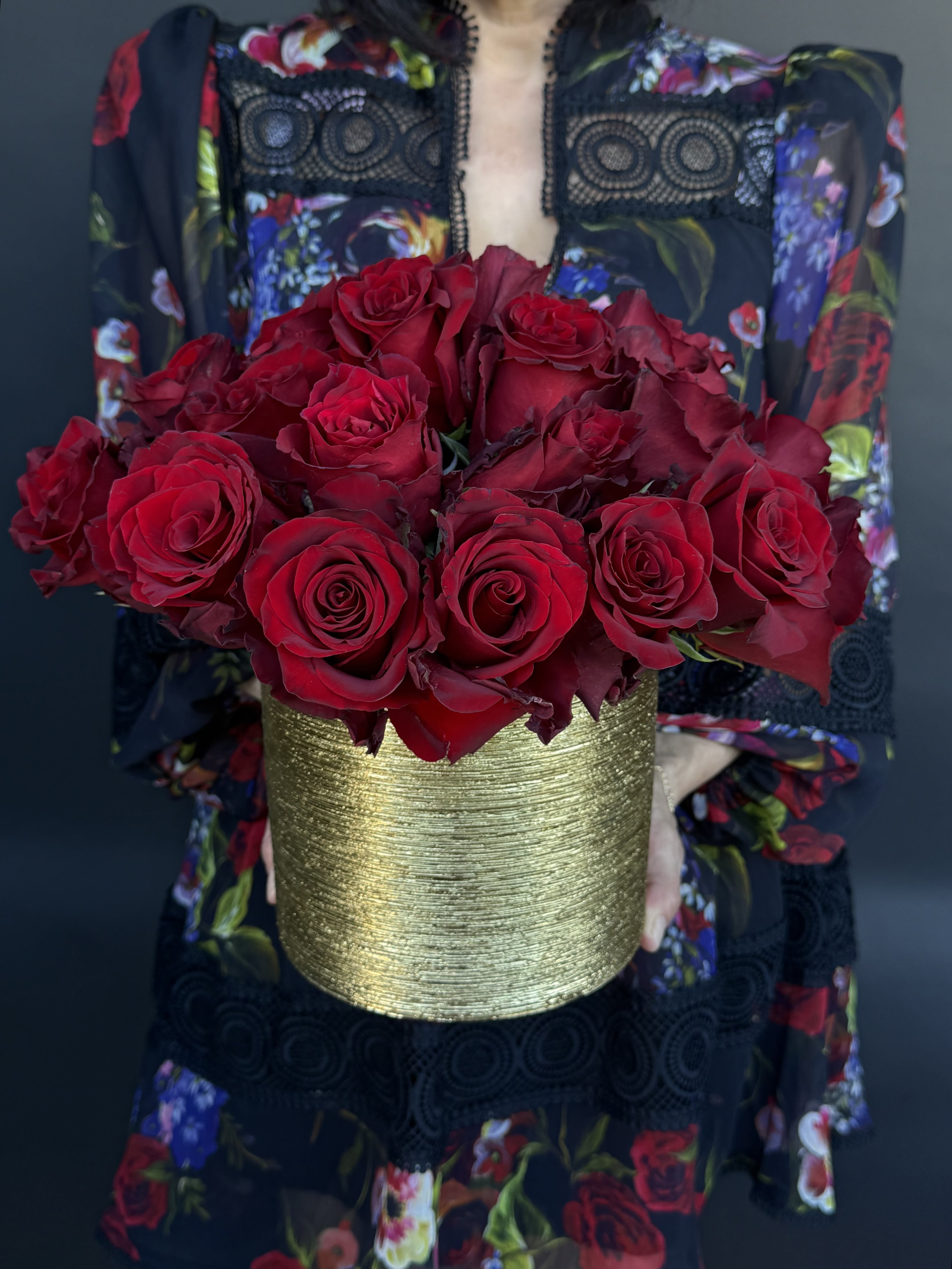 Bouquet of red roses in a gold textured vase