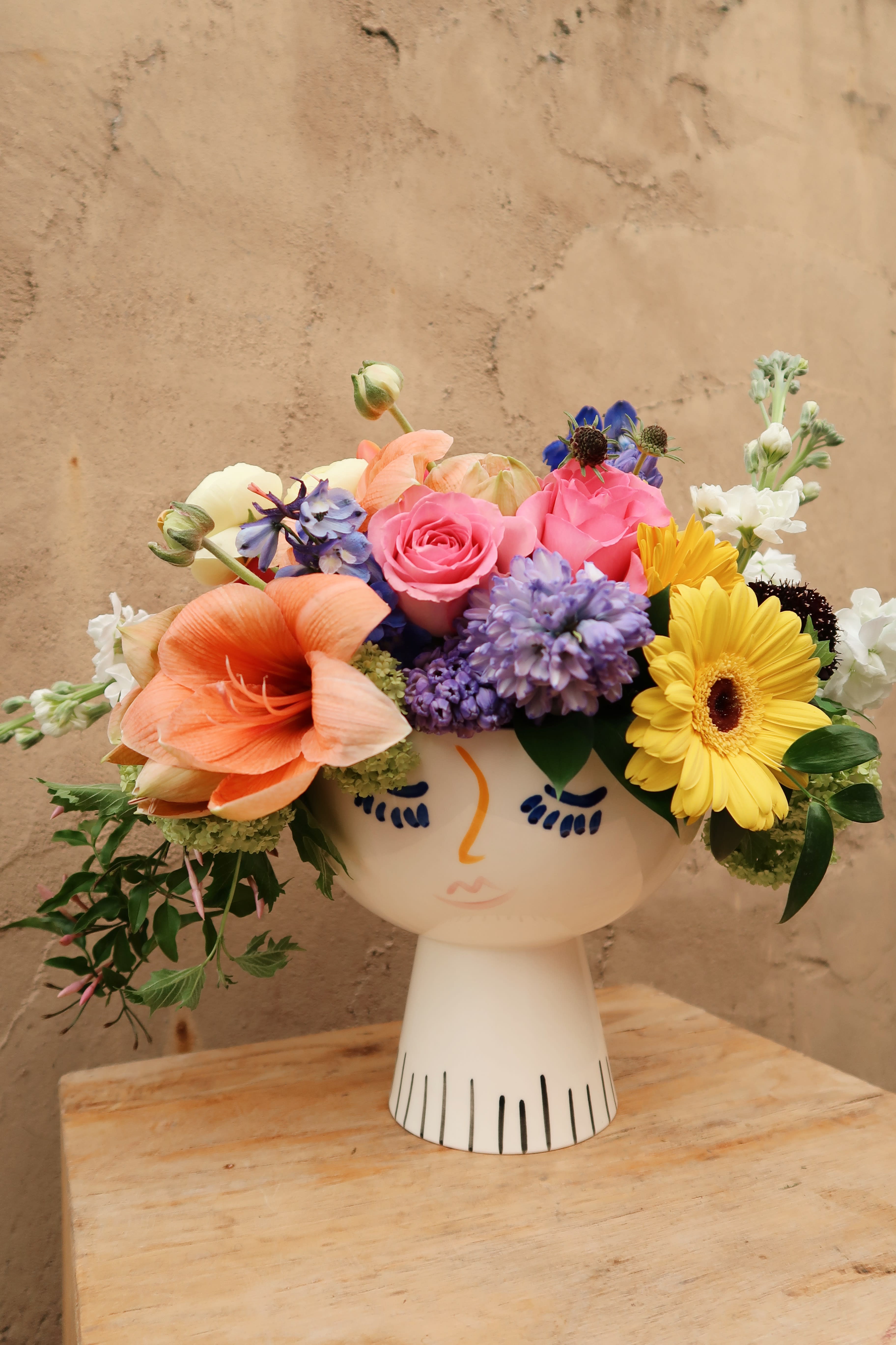 Lola - Lola face vase filled with the seasons blooms, bright and beautiful.