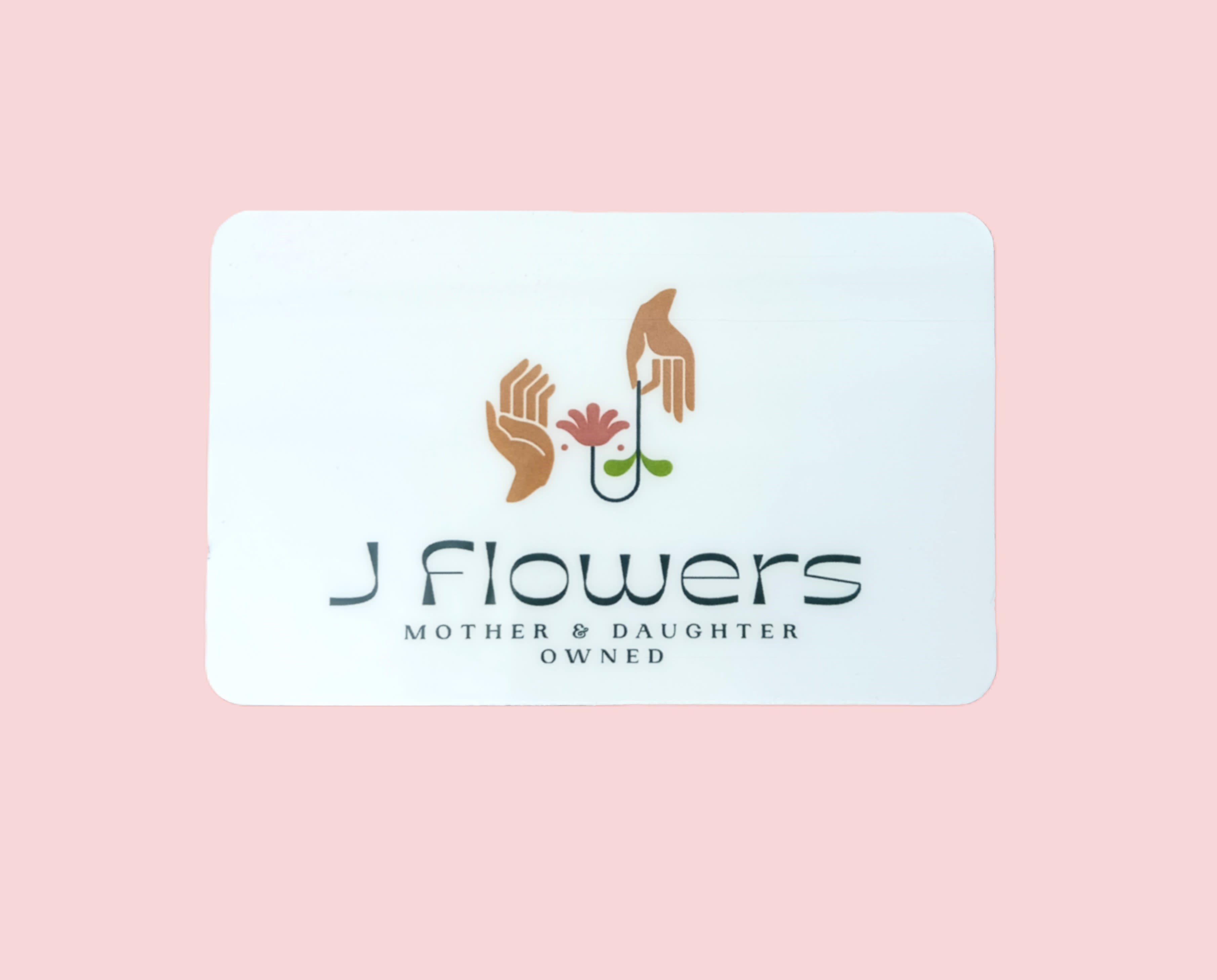 White business card with a flower logo on a pink background