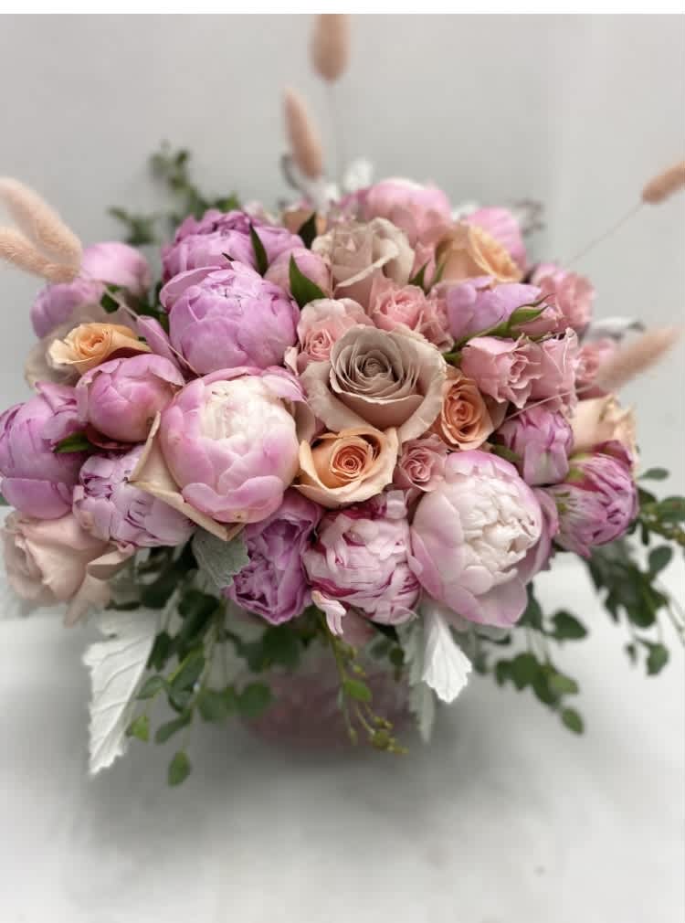 Pink and peach bouquet of peonies and roses in a vase