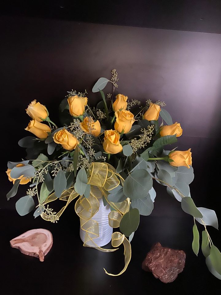 Stylish Yellow Dozen Roses in eucalyptus hug - MORE DESIGNS at : 6starfloristcorina.com . Feel free to check our website for more details about our services.   Stylish Yellow Dozen Roses in eucalyptus hug is the perfect "pick me up" to brighten someone's anniversary , birthday, get well, just because, and thank you.  NOTE: Eucalyptus may vary depend on the availability. Flowers: Roses  may vary in shades. Vase may vary (white or clear).For Valentine/s Day and Mother's Day vases are different than  the picture. We provide a special design vase for special holidays. 