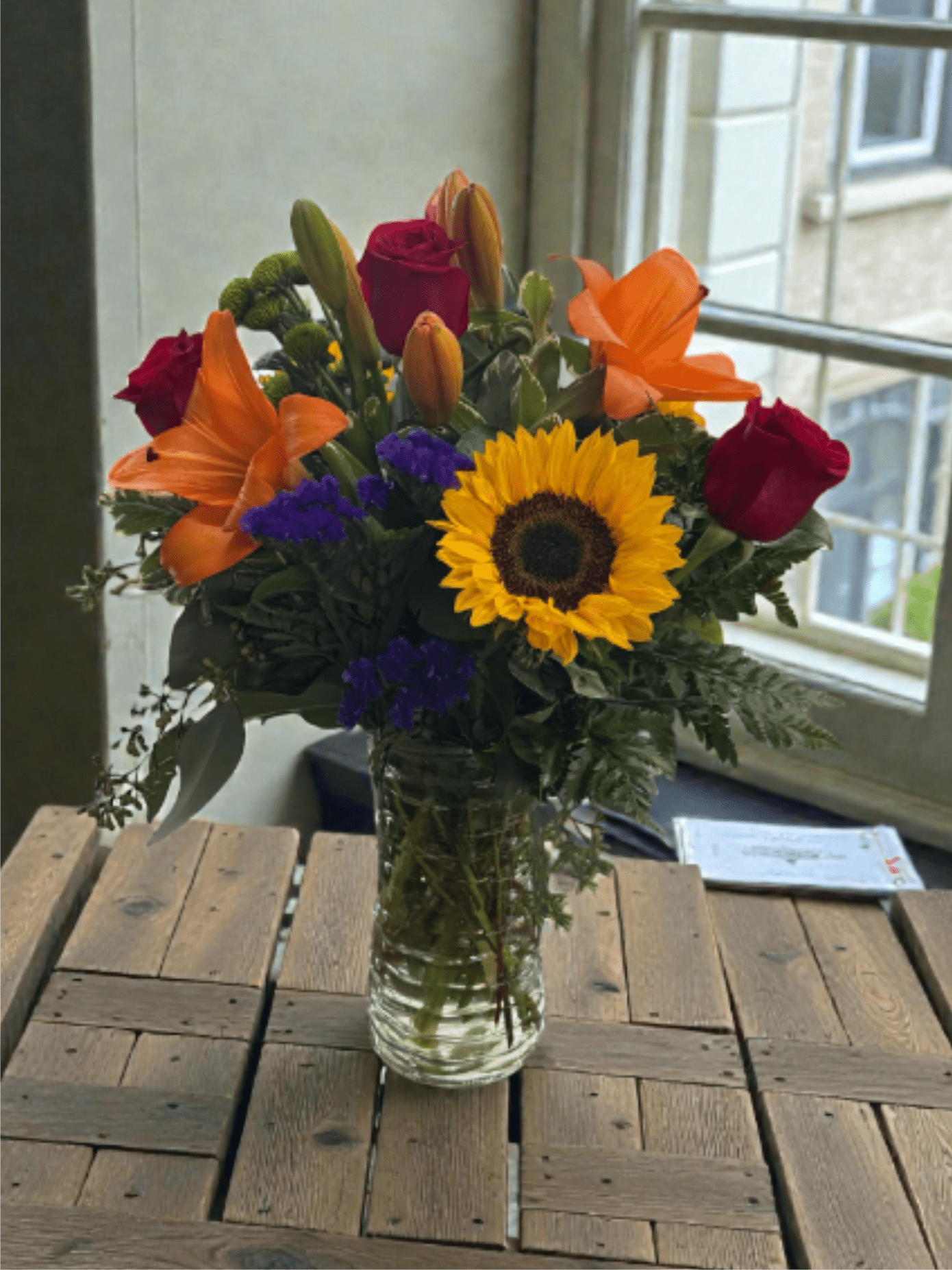 The Blooming Marvellous  - A mix of sunflowers, lilies, statice, rose, buttons, and assorted greens.