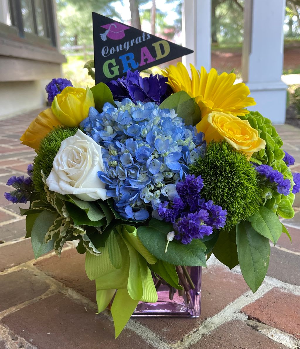 Congrats Graduate! - This graduation flower gift is a great way to honor the graduate! Tax free. Hand delivered, same day delivery. Please note graduation pick may vary.  We are a local florist in Wilmington, Delaware that provides the best delivery of fresh flowers on the same day. We also offer next day delivery. Our flower shop services the Wilmington and Newark Delaware areas as well as south eastern PA. We are a flower shop near you that is tax free and provides hand delivered flowers. We offer funeral, sympathy, anniversary, birthday, holiday, Mother's Day, Valentine's Day and rose arrangements and flowers for all occasions. Petals is a full service florist that offers the best online flowers and fresh flower arrangements. You can send flowers from our flower shop to Wilmington, New Castle, Newark, Hockessin, Chadds Ford, Kennett Square and other local cities near us. 