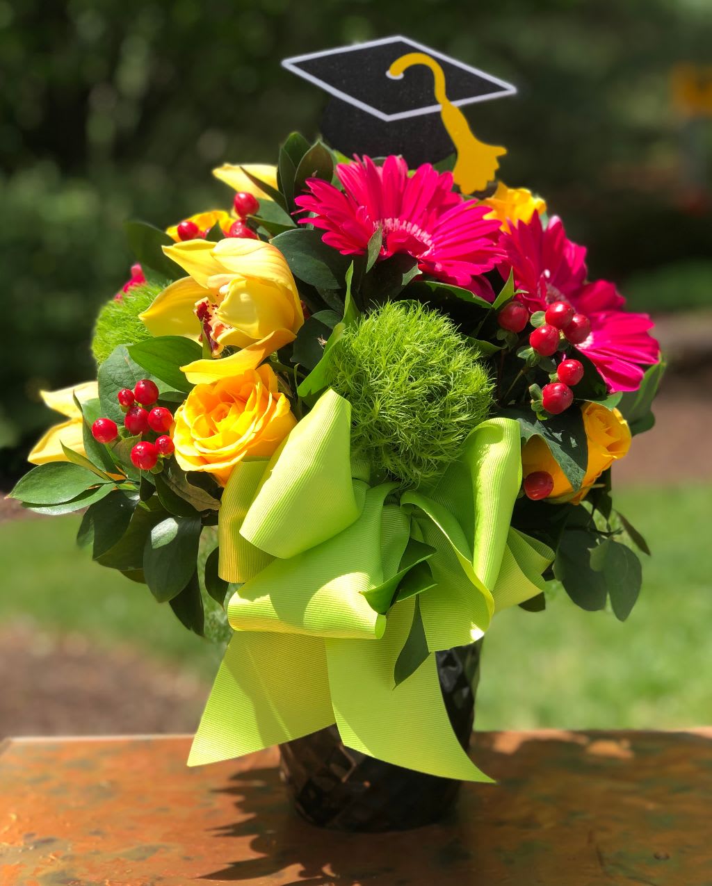 Congrats Grad! - Tell your loved one congratulations with the bright and cheerful arrangement. Please note graduation pick may vary. Tax free. Same day hand delivery.  We are a local florist in Wilmington, Delaware that provides the best delivery of fresh flowers on the same day. We also offer next day delivery. Our flower shop services the Wilmington and Newark Delaware areas as well as south eastern PA. We are a flower shop near you that is tax free and provides hand delivered flowers. We offer funeral, sympathy, anniversary, birthday, holiday, Mother's Day, Valentine's Day and rose arrangements and flowers for all occasions. Petals is a full service florist that offers the best online flowers and fresh flower arrangements. You can send flowers from our flower shop to Wilmington, New Castle, Newark, Hockessin, Chadds Ford, Kennett Square and other local cities near us. 