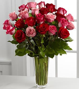 Bouquet of red and pink roses in a clear glass vase