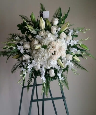 Large white floral standing spray on an easel