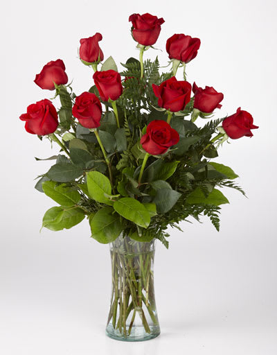Red roses arranged in a clear glass vase