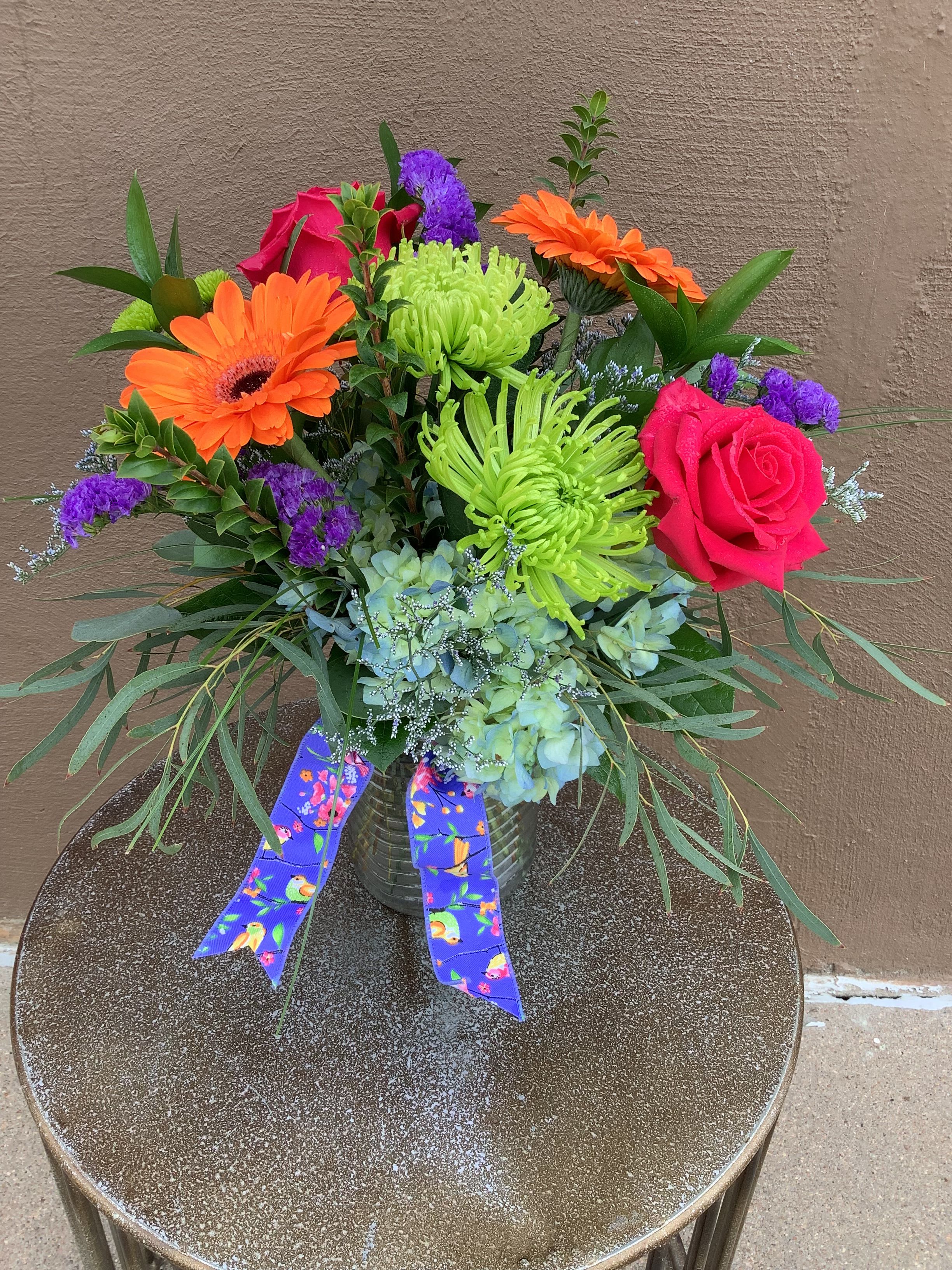 Tropical Punch - Beautiful blue hydrangea, orange gerbera, green spiders and hot pink roses make such a beautiful combination.