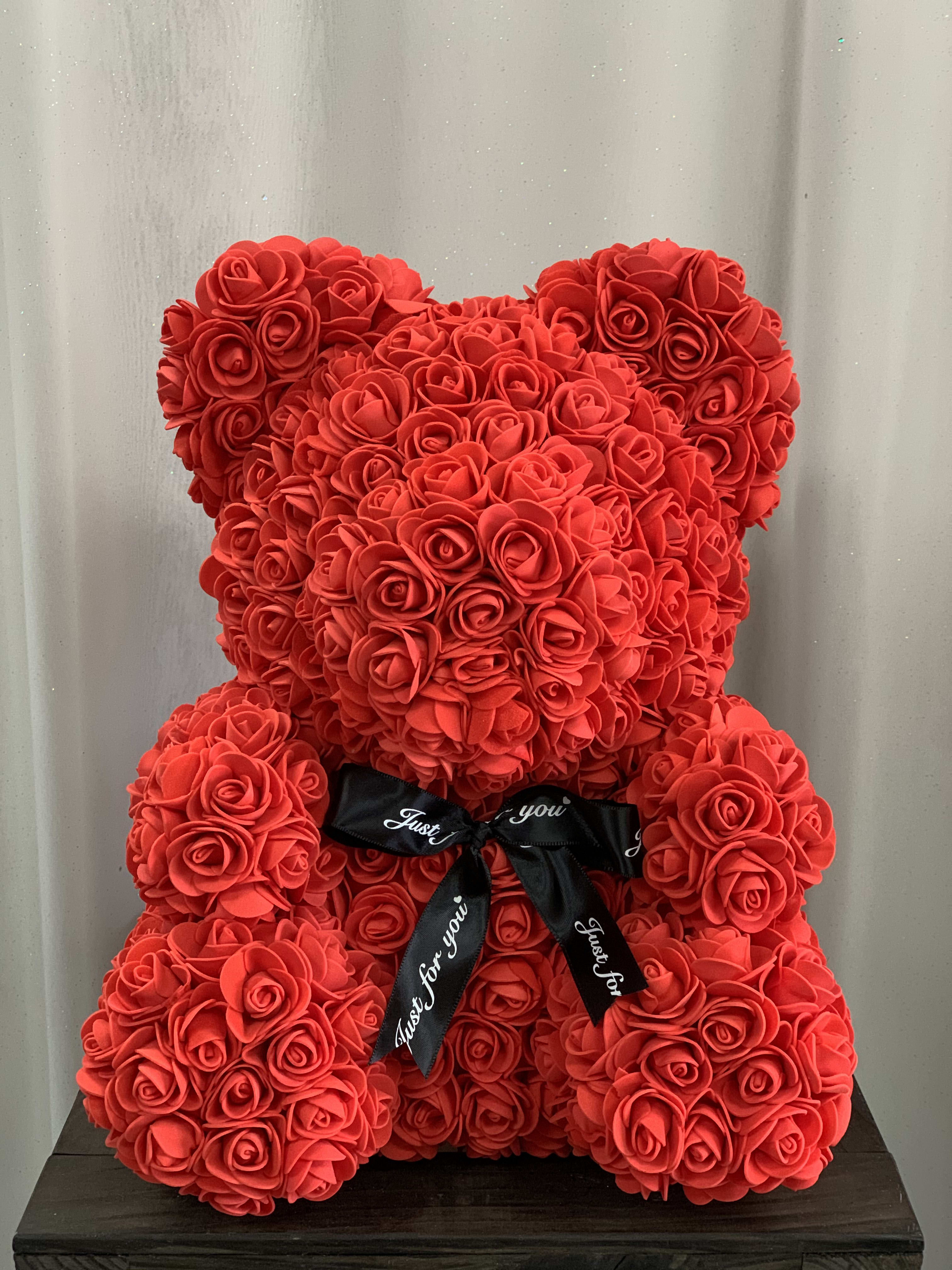 Faux Red Rose Teddy Bear - Each lovely, Styrofoam, Rose Teddy Bear is 100% handmade and covered with soft, faux, rose petals that are individually added. Each bear arrives in a window display box that is 15 in height and 11 in width, perfect for sitting on a shelf or table. They're designed to be durable and will last a lifetime if handled with care. They make a beautiful and eye-catching decoration in any room or even at the office. Every time she looks at it, she'll remember that special day. What a sweet memento!  Bear Dimension: 13" H x 10"W 