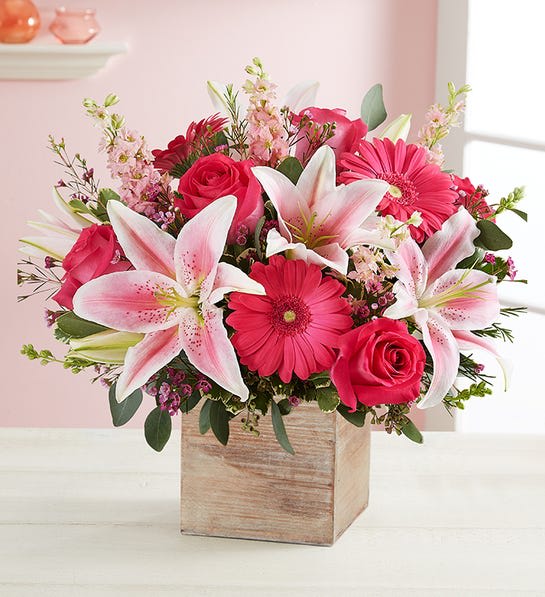 Dream Come True™ Bouquet - We’ve brought together a dreamy mix of pink blooms, with hints of purple and lush green. Our grey-washed wooden cube provides the perfect contrast of tones and textures. Full of warmth and sweetness, it’s a gift that celebrates the blissful feeling of being in love.  All-around arrangement with hot pink roses; pink Oriental lilies, Gerbera daisies and larkspur; purple waxflower; accented with seeded eucalyptus, silver dollar eucalyptus and assorted greenery Artistically designed in our exclusive grey washed wooden cube with rustic style and natural, textural beauty; measures 5.2"L x 5.2"H x 5.2"W Large arrangement measures approximately 12"H x 12"W Medium arrangement measures approximately 10"H x 10"W Small arrangement measures approximately 9"H x 9"W Our florists hand-design each arrangement, so colors and varieties may vary due to local availability To ensure lasting beauty, Oriental lilies may arrive in bud form and will fully bloom over the next few days