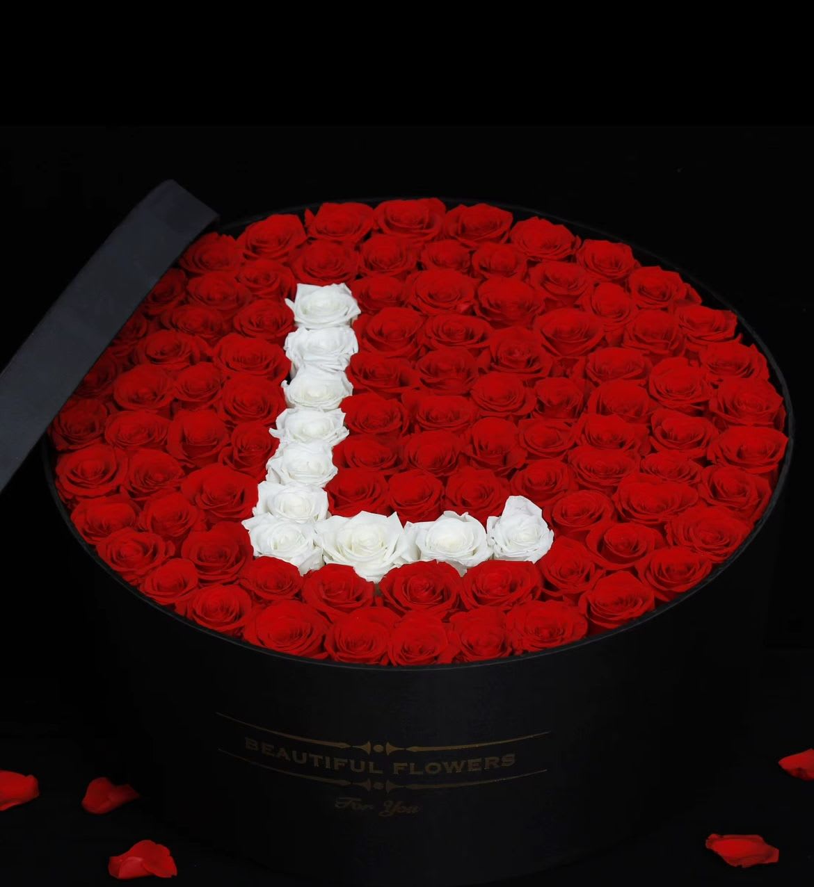 Oval box of red roses with a white rose letter L