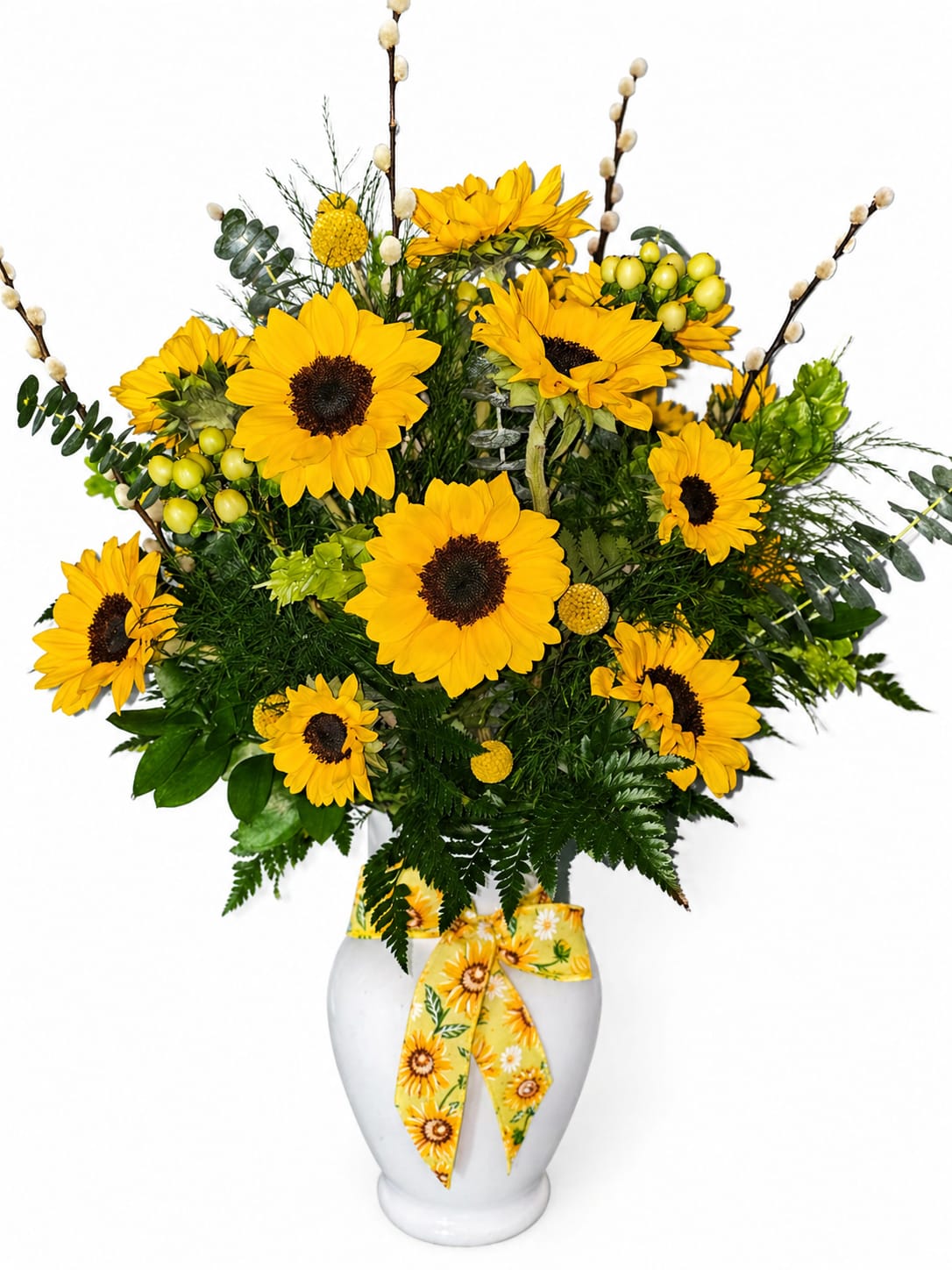 Golden Sunshine Bouquet - Celebrate Mom with the warmth and beauty she deserves. Our Mother’s Day Golden Sunshine Bouquet is a heartfelt expression of love, featuring radiant yellow sunflowers that symbolize happiness, admiration, and unwavering support—just like her.  This lush arrangement is thoughtfully designed with vibrant sunflowers, fresh seasonal greenery, and delicate textural accents, creating a full and elegant display. Arranged in a classic white ceramic vase and finished with a charming sunflower ribbon, it’s a gift that feels both timeless and full of joy.  Perfect for brightening her home and her heart, this bouquet is a beautiful way to say “Thank you for everything.”