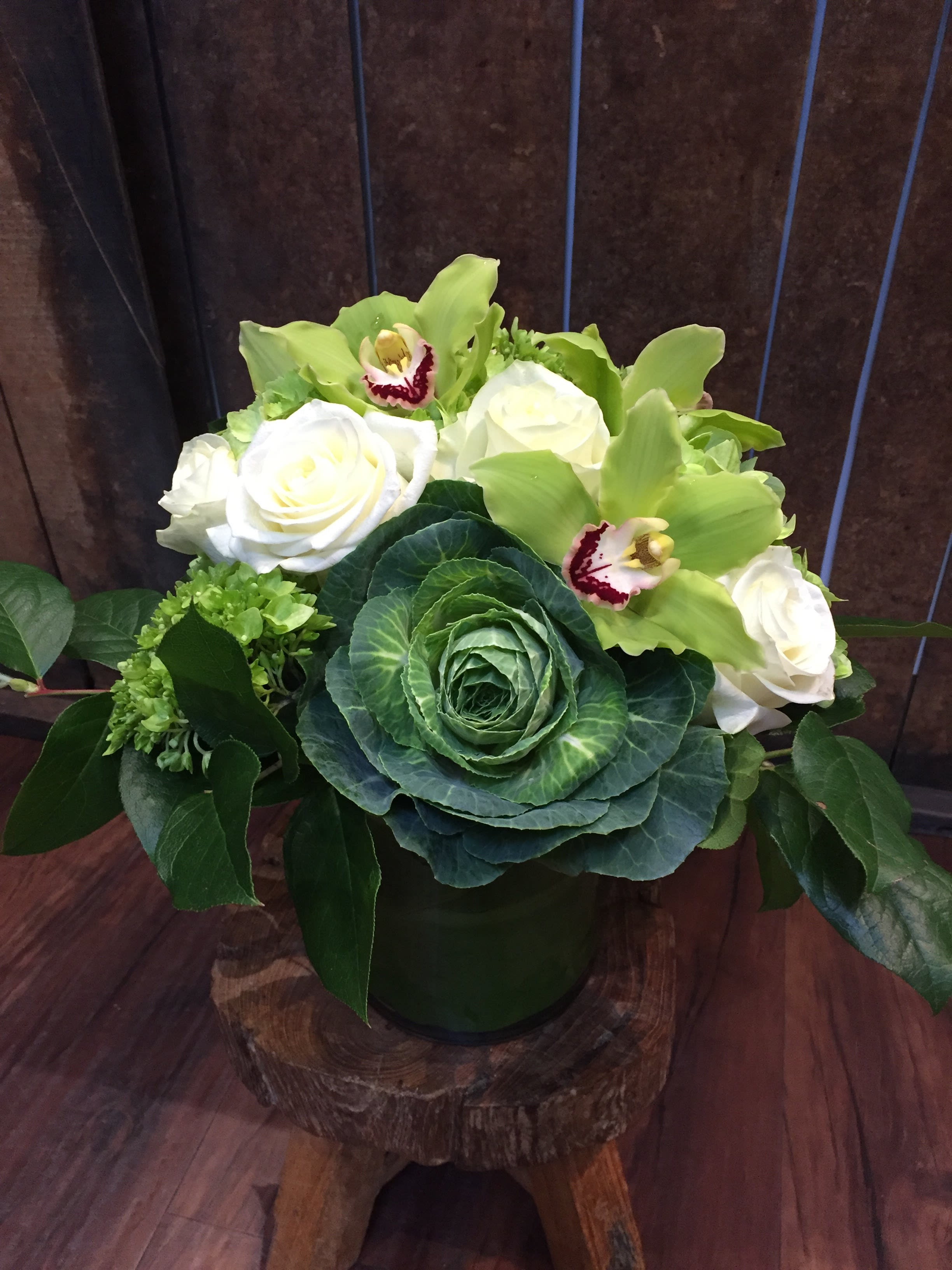 Feelin' Green - A mix of brightly colored greens accompanied by white roses, green hydrangea, and cymbidium orchids. 