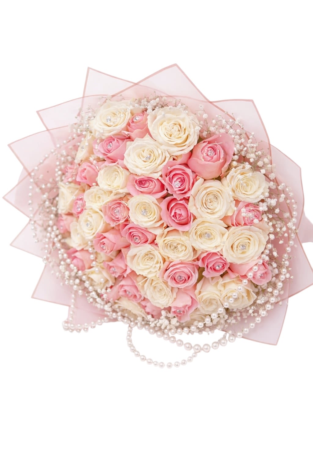 Pink and cream rose bouquet wrapped in pale pink paper with pearl accents