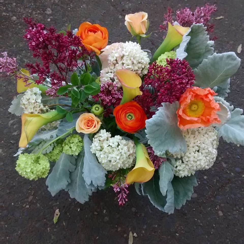 Spring Clouds - This fragrant mix- shown here: lilacs, roses, calla lilies, etc. is like adding a cloud of sweetness into your life  ***Please note that Emerald Petals creates with the seasons. What you see pictured is a representation of our style and the general size of the bouquet, intentional substitutes will be made as needed as all of our arrangements are one of a kind like you **A clear vase will be used unless specified