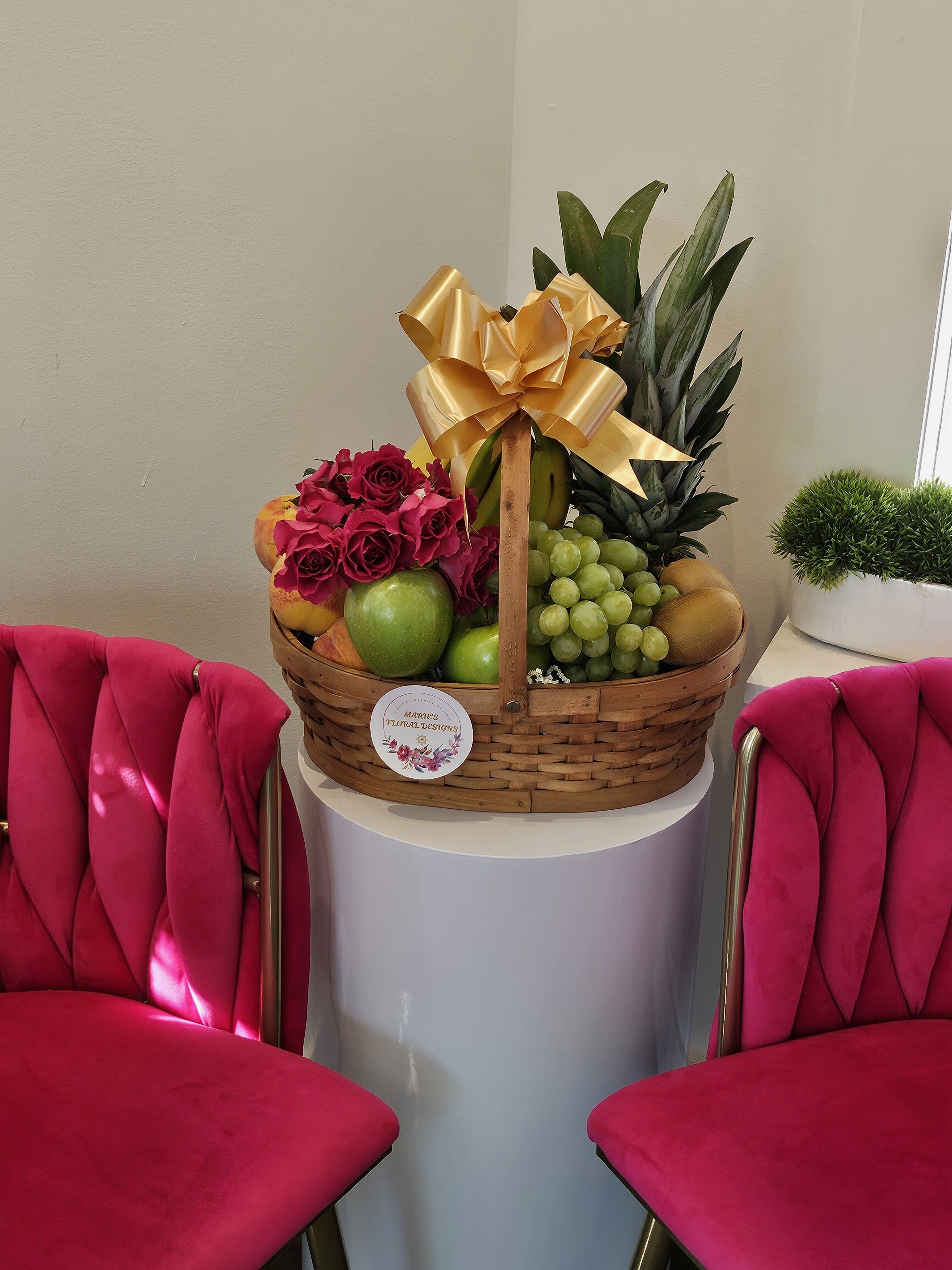 Fruit basket with roses and a gold bow