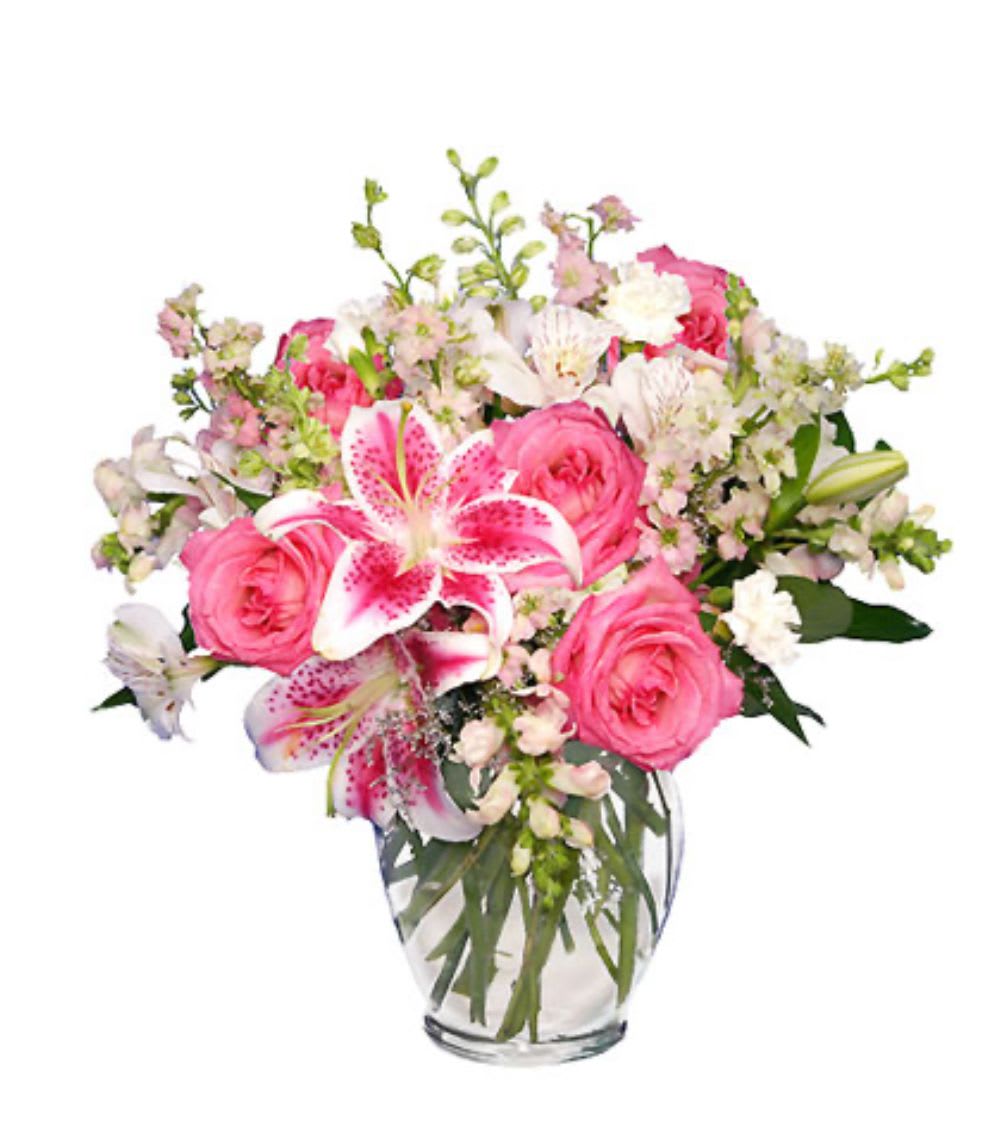 Pink roses and lilies in a clear glass vase