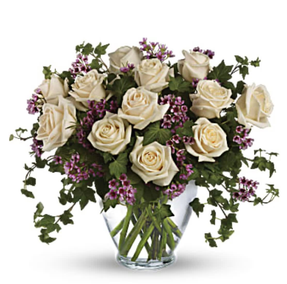 Cream roses with purple filler in a clear glass vase