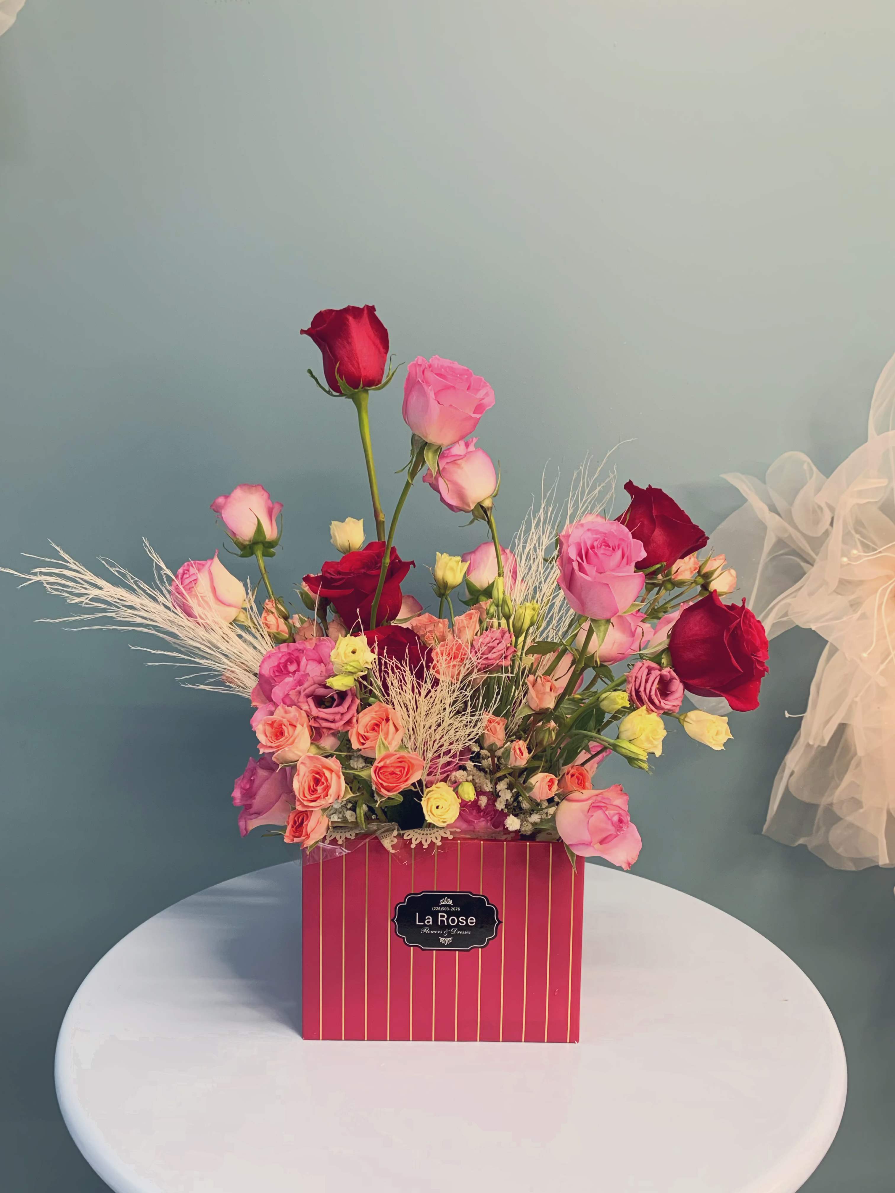 "Love Elegance" Flower Box - Celebrate love with our Valentine's Day " Love Elegance " flower boxes.   Each box is a masterpiece, featuring a curated selection of blooms. Choose from chic expressions with delicate roses and vibrant blooms, bold red roses for a passionate statement, or soft pastels for an elegant touch. Perfect for gifting or gracing any romantic setting, these flower boxes bring sophistication and charm to your special day.  standard size : 14-16 stems of florals deluxe size:  20-24 stems of florals 