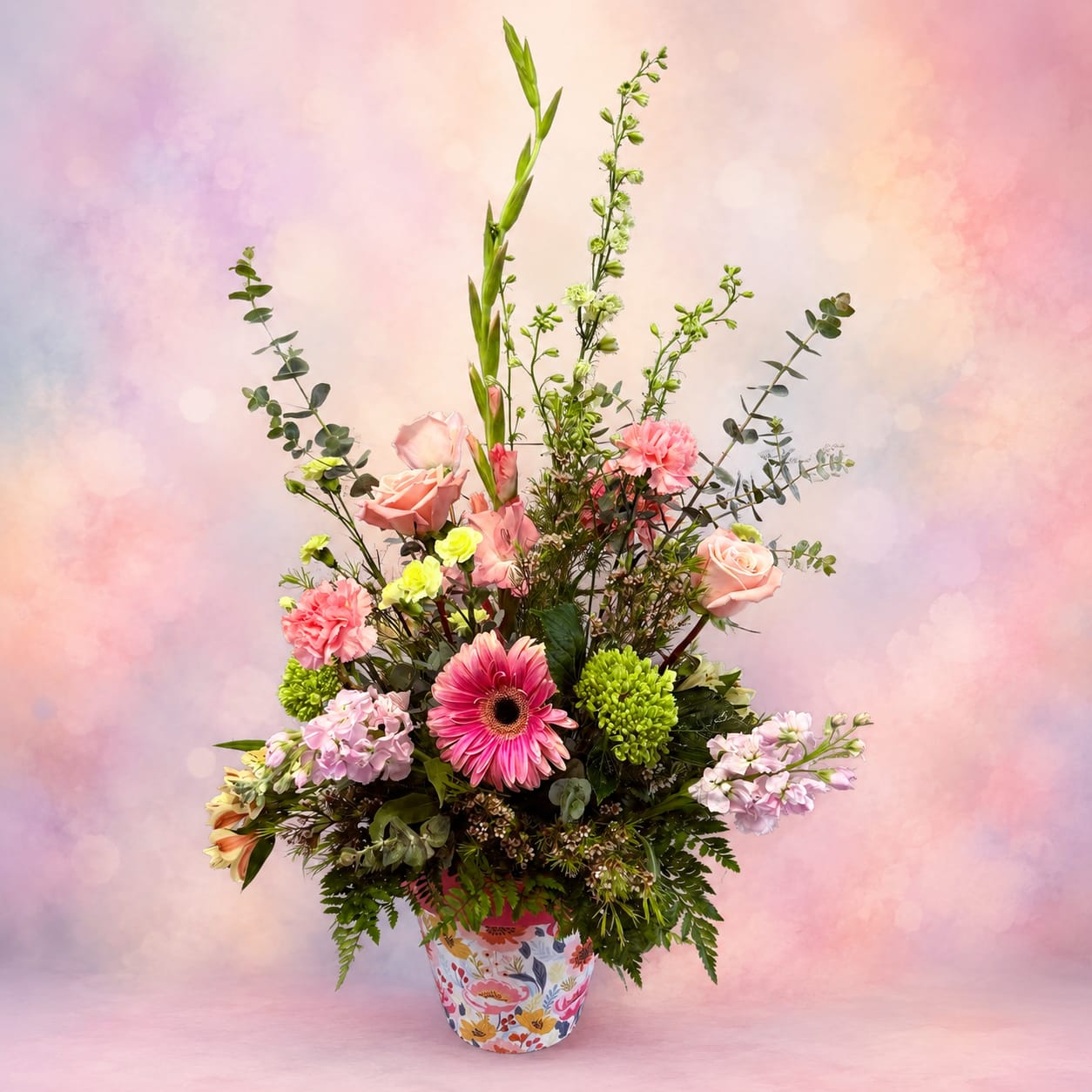 Garden Party - Garden Party is a lush, garden-inspired arrangement overflowing with soft pastel blooms, elegant textures, and fresh seasonal beauty. Designed with a gathered, airy feel and arranged in a 8" charming pot, this stunning bouquet is the perfect way to celebrate in a grand and meaningful way. Full of color, love, and graceful blooms, it’s a beautiful statement gift for any occasion.