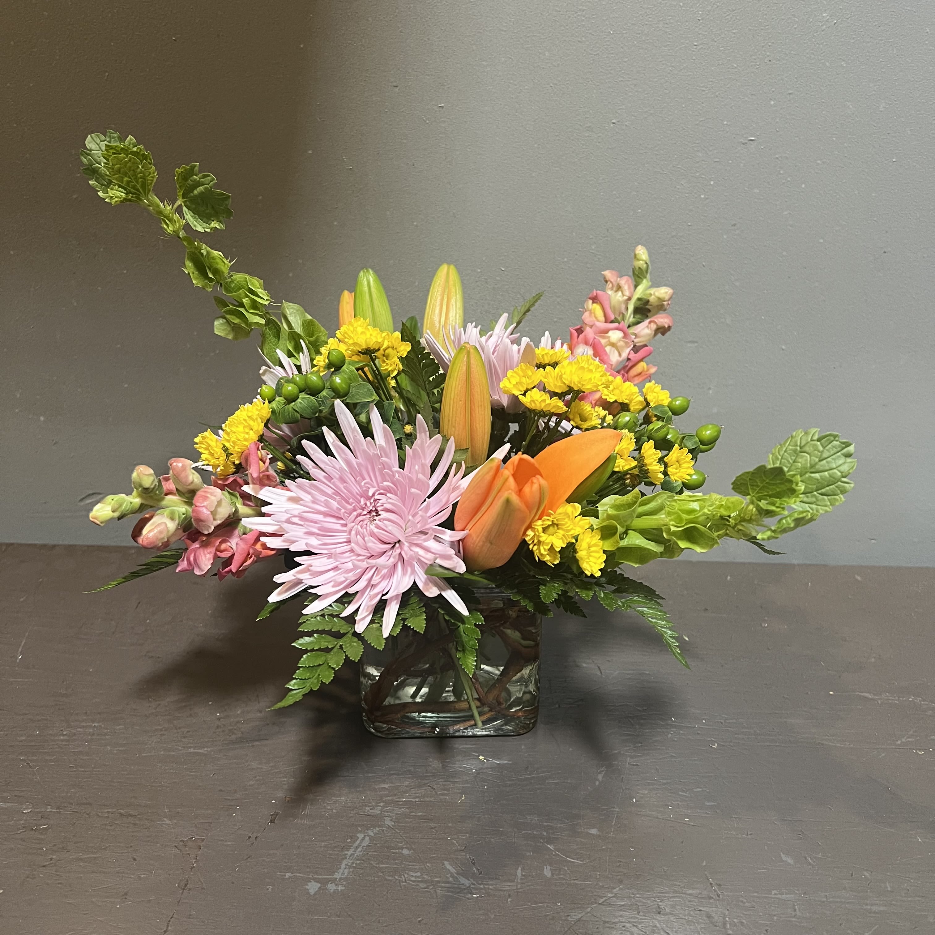 English Contemporary Bouquet - Brighten up your day with a beautiful English contemporary piece!  Measures approx. 13" tall x 13" wide and arrives in a clear vase.