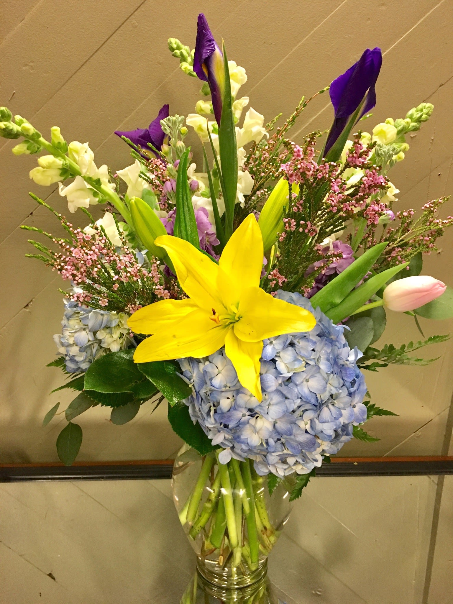 Spring Morning - Welcome spring with blooms of hydrangeas, lilies, snapdragons, iris and tulips arranged in a glass vase.